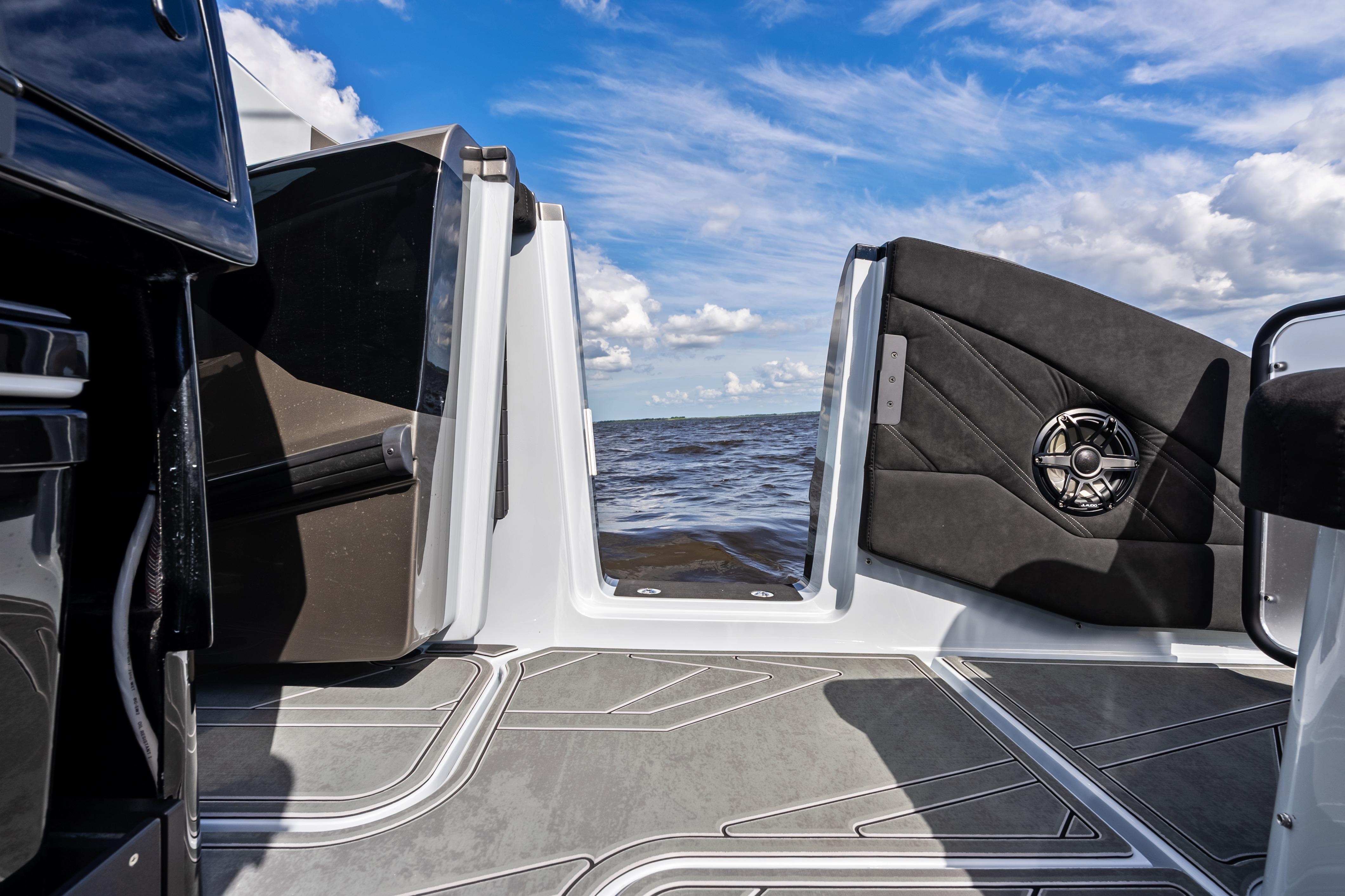 2027 Mystic Powerboats M4200 interior view with open door, showcasing ocean and sky.