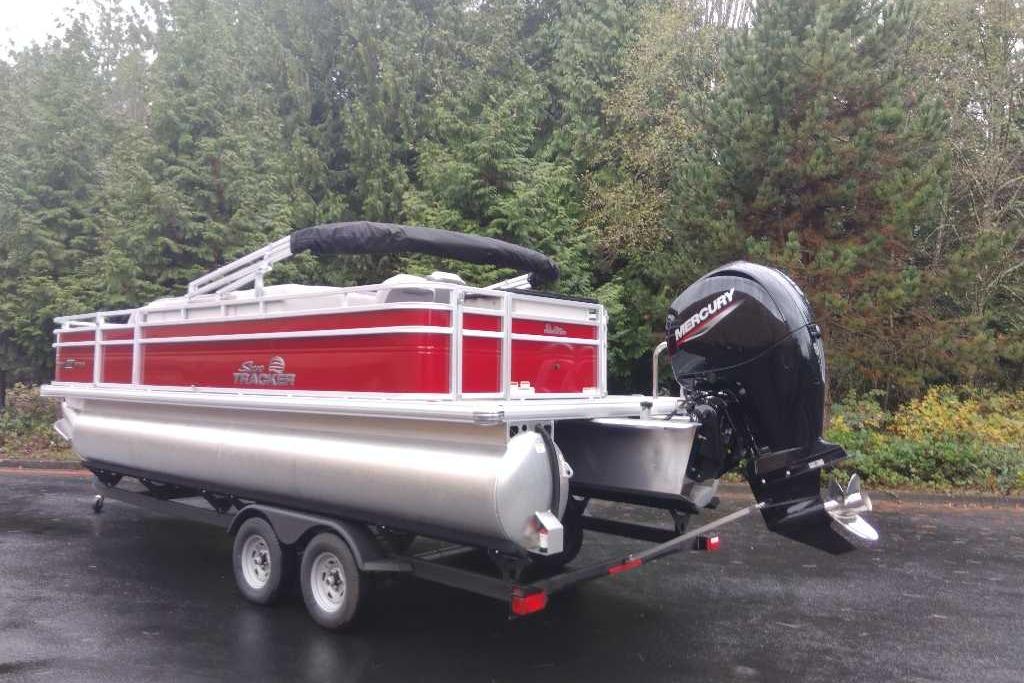 2026 Sun Tracker Fishin' Barge 22 DLX pontoon boat with Mercury outboard motor.