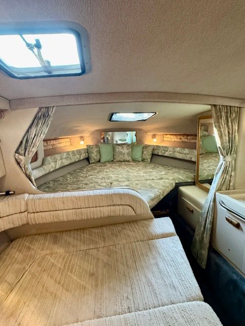 Interior of the 1992 Sea Ray 290 Sundancer with cozy bed and seating area.