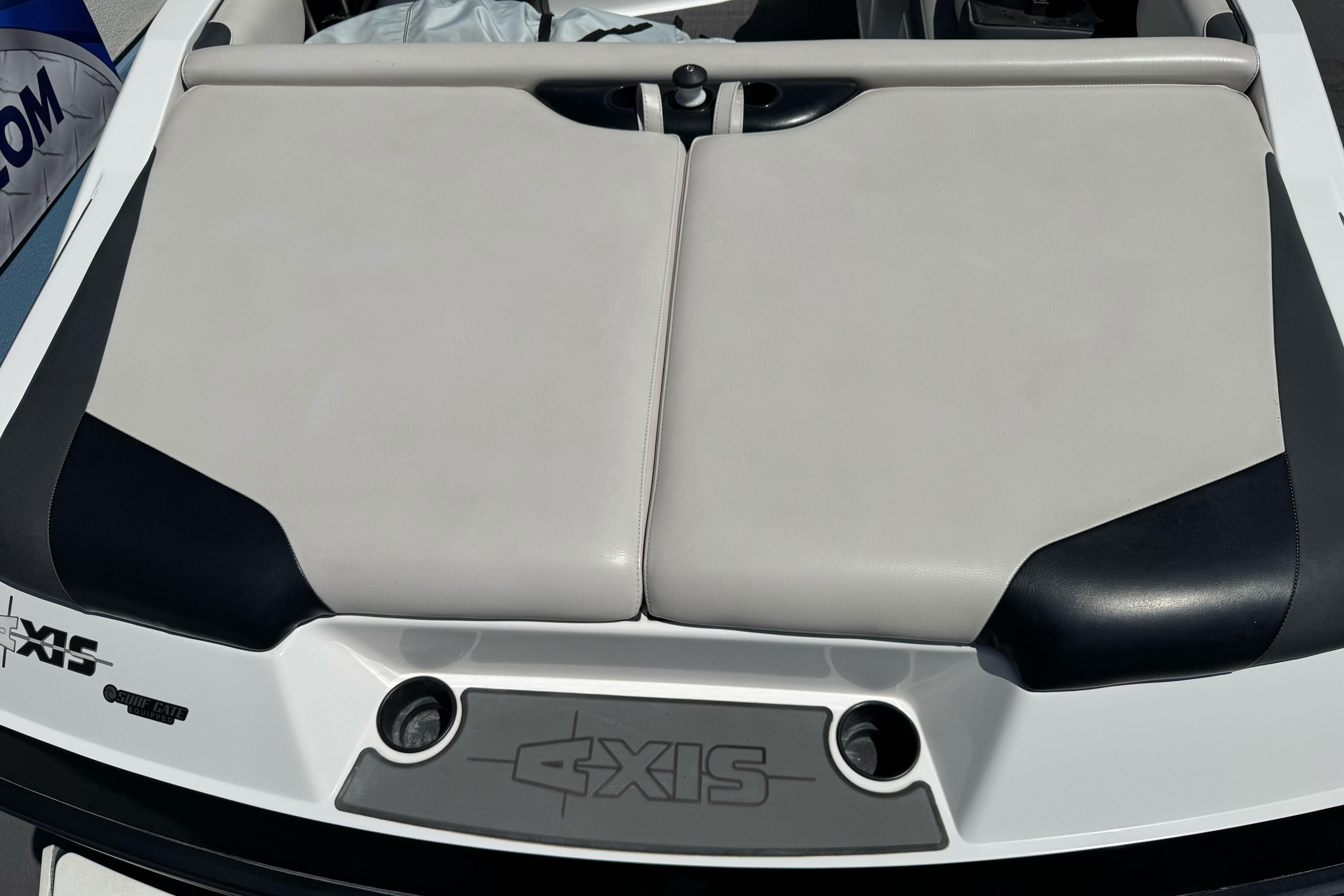 2015 Axis A20 boat rear seating area with logo and cup holders.
