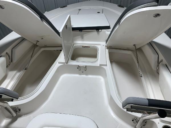 2024 Robalo 246 Cayman boat storage compartments and seating area.