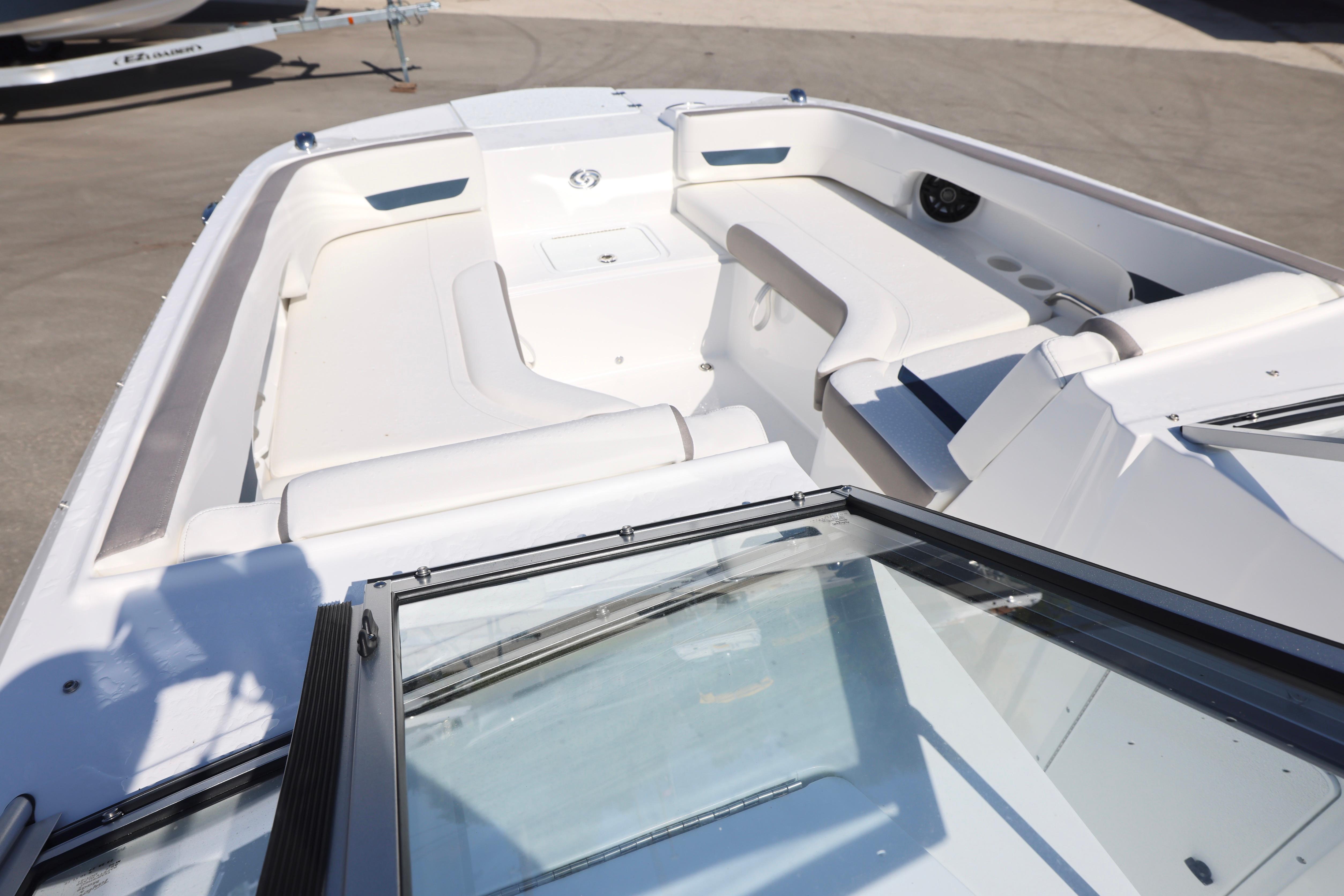 2026 Hurricane SunDeck 235 OB boat interior with white seating and open deck layout.
