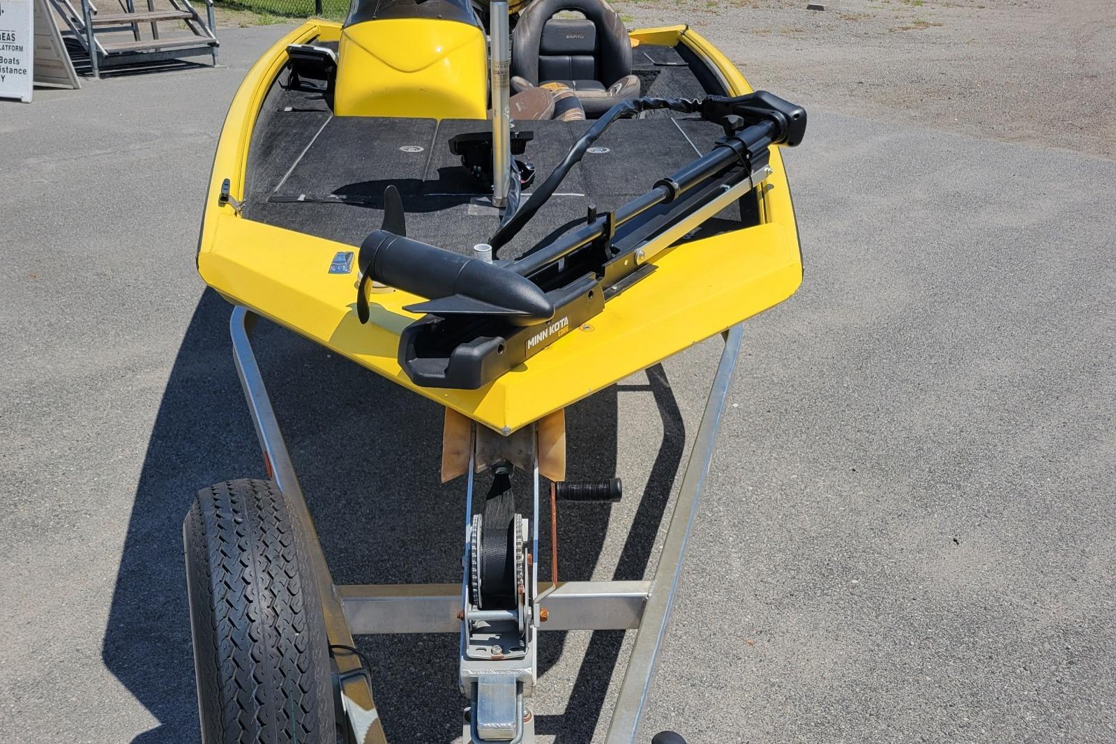Yellow Excel 1751 F4 boat on trailer, 2011 model, with trolling motor.