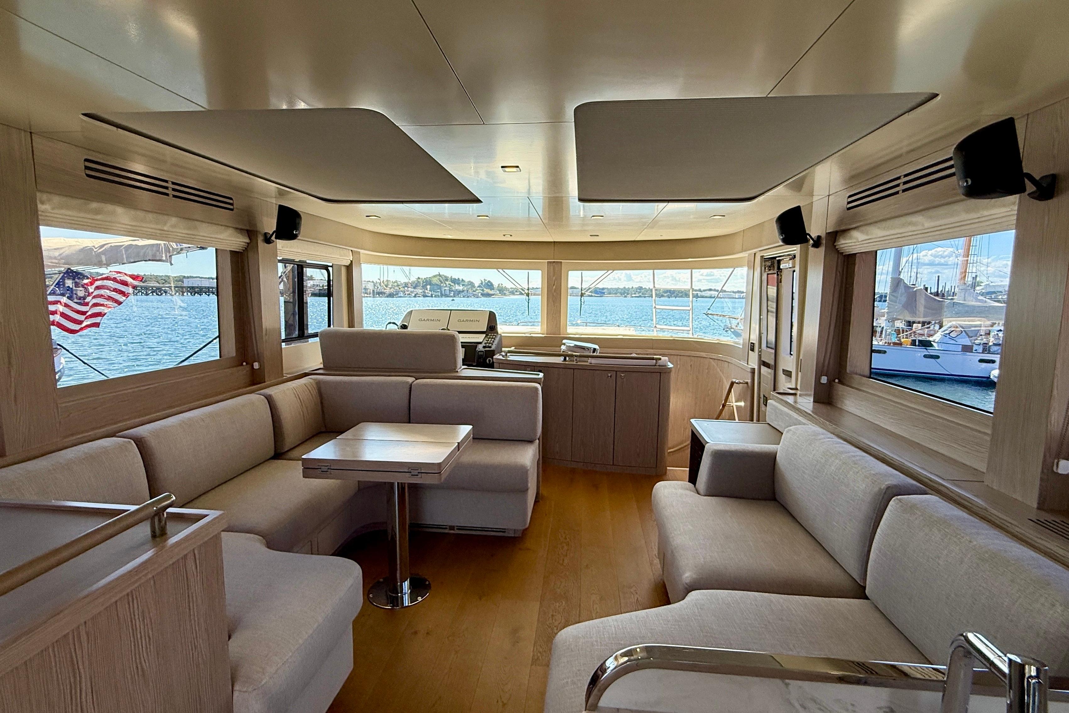 Luxurious interior of 2022 Sirena 58 yacht with elegant seating and panoramic windows.