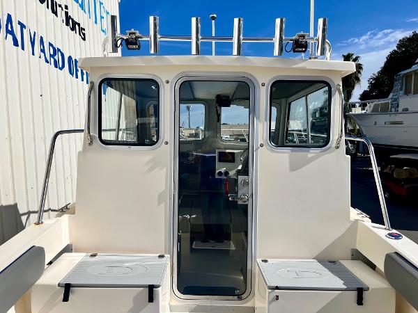 2023 Defiance Admiral 220 EX boat cabin with seating and glass door.