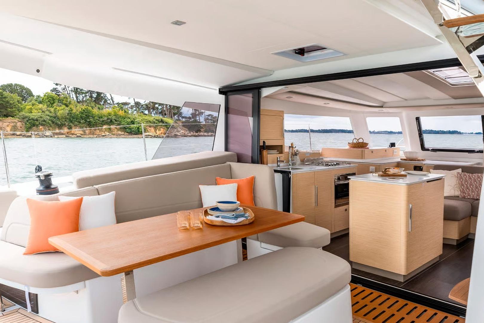 Luxurious interior of 2026 Fountaine Pajot NEW 41 catamaran with modern kitchen and dining area.