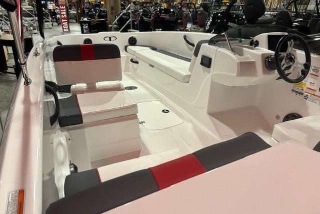 2026 Tahoe T18 boat interior with red and gray seating, showcased at a boat sale event.
