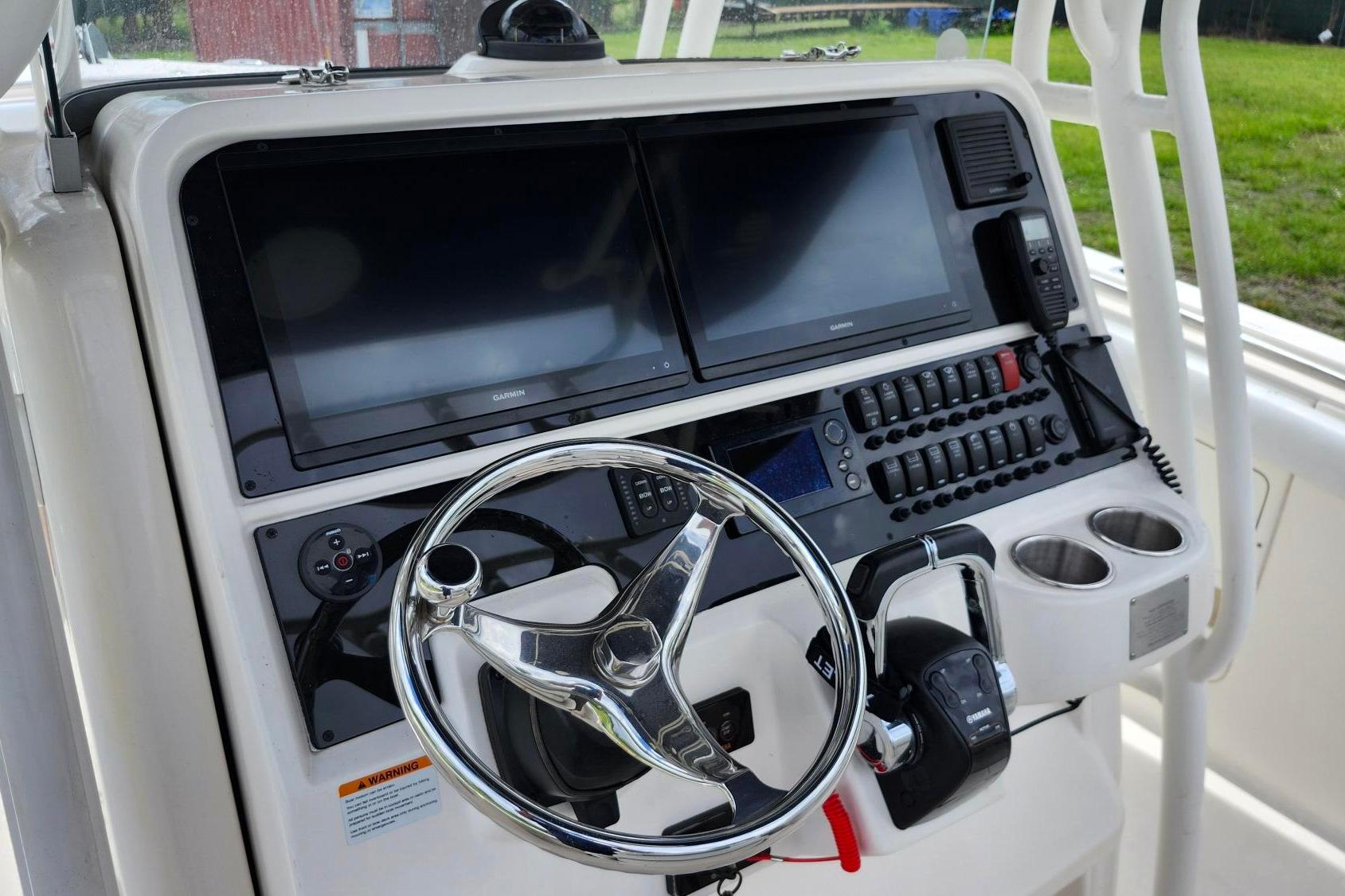 2015 Robalo R300 Center Console helm with dual displays and controls.
