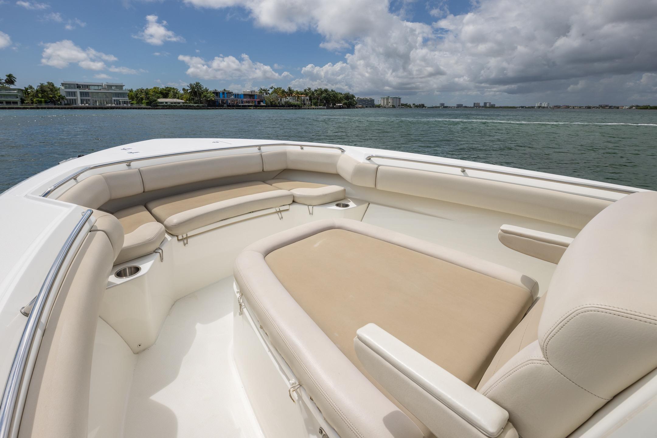 2016 Boston Whaler 280 Outrage boat interior with beige seating, on a sunny day.