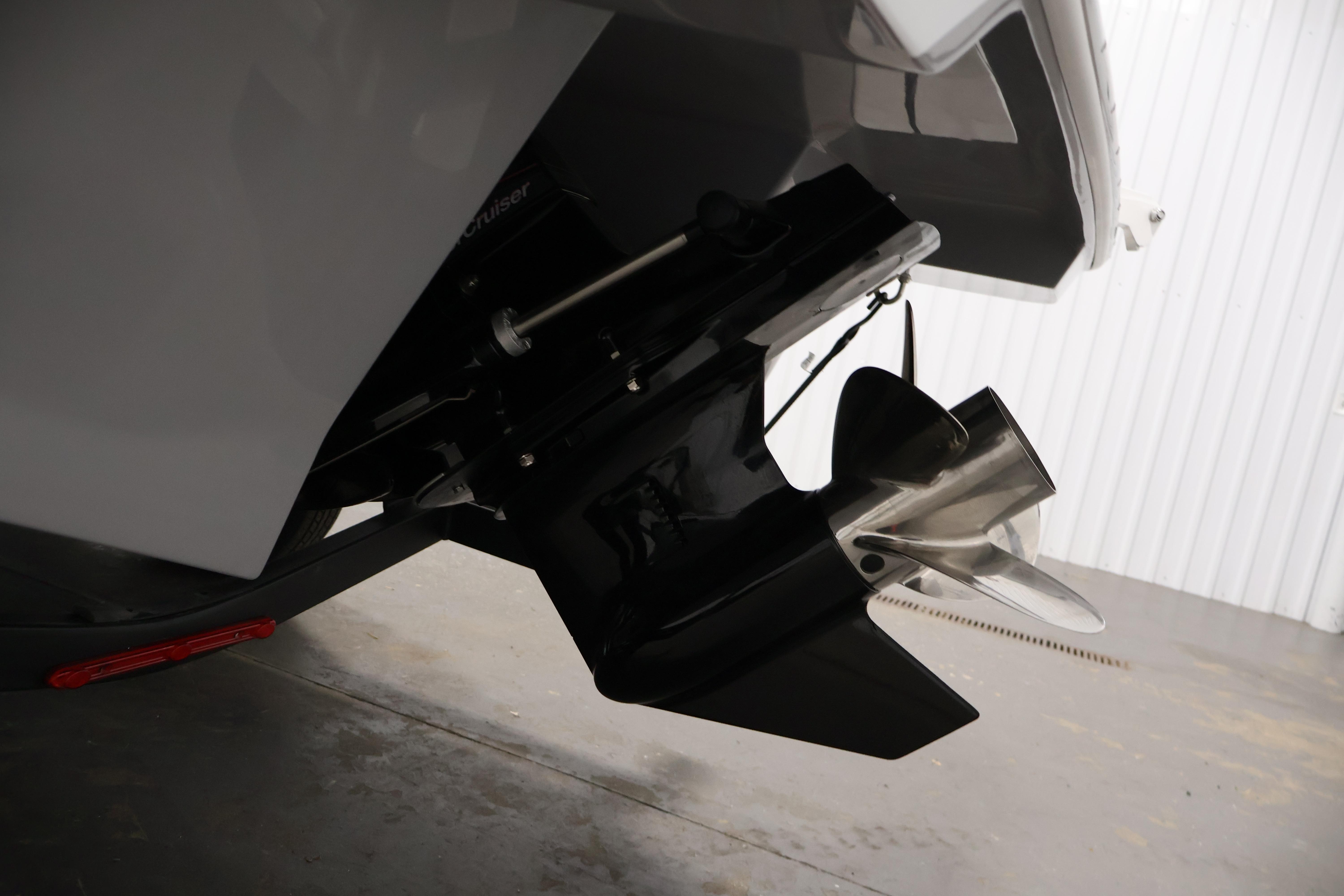 2026 Four Winns H4 Freedom boat propeller and stern detail in a garage.