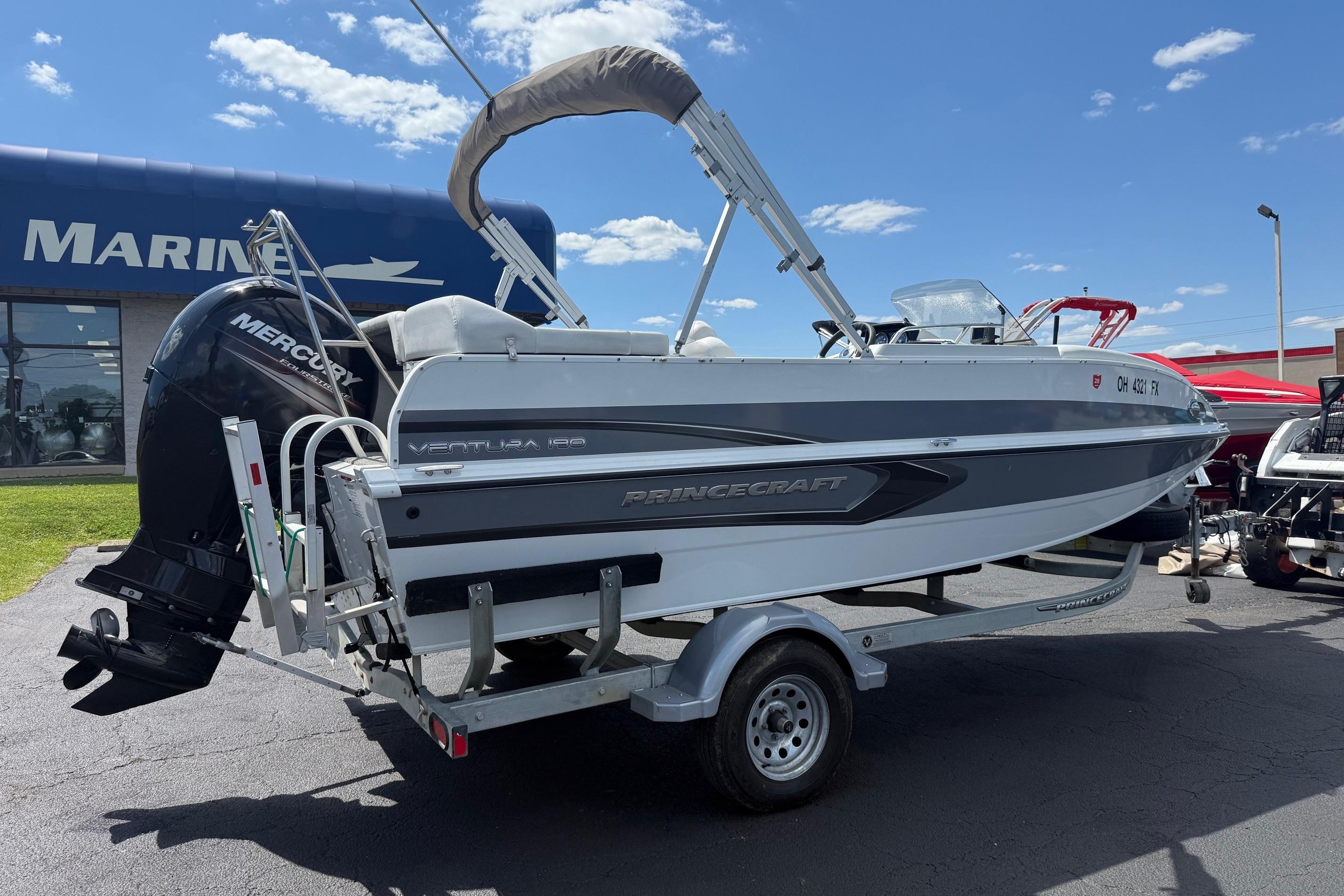 2019 Princecraft Ventura 190 boat on trailer, displayed outdoors near marine dealership.