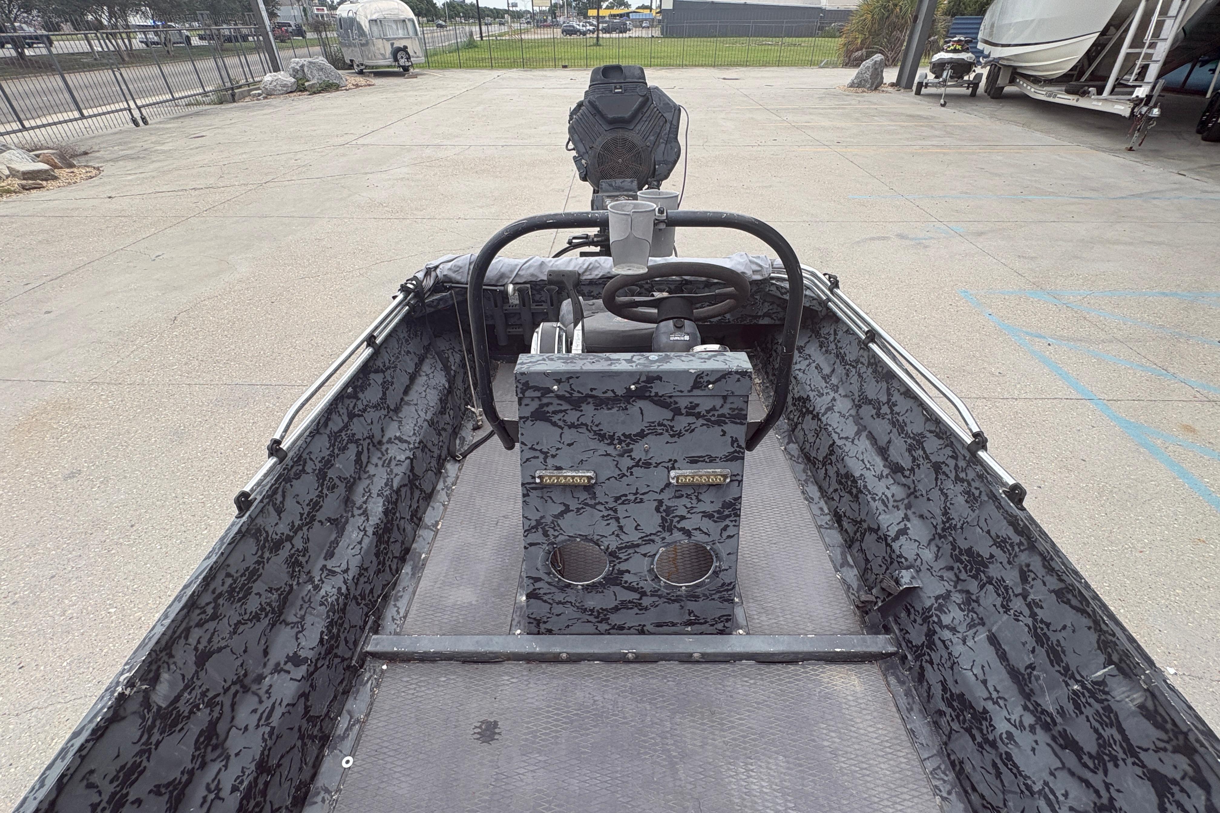 2020 Gator Tail Extreme boat interior with camouflage design, steering console, and spacious layout.