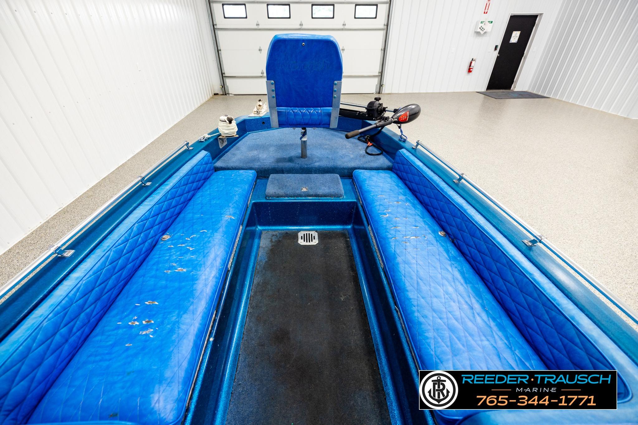1980 Ranger 175 VS boat interior with blue seating and motor, in a garage setting.