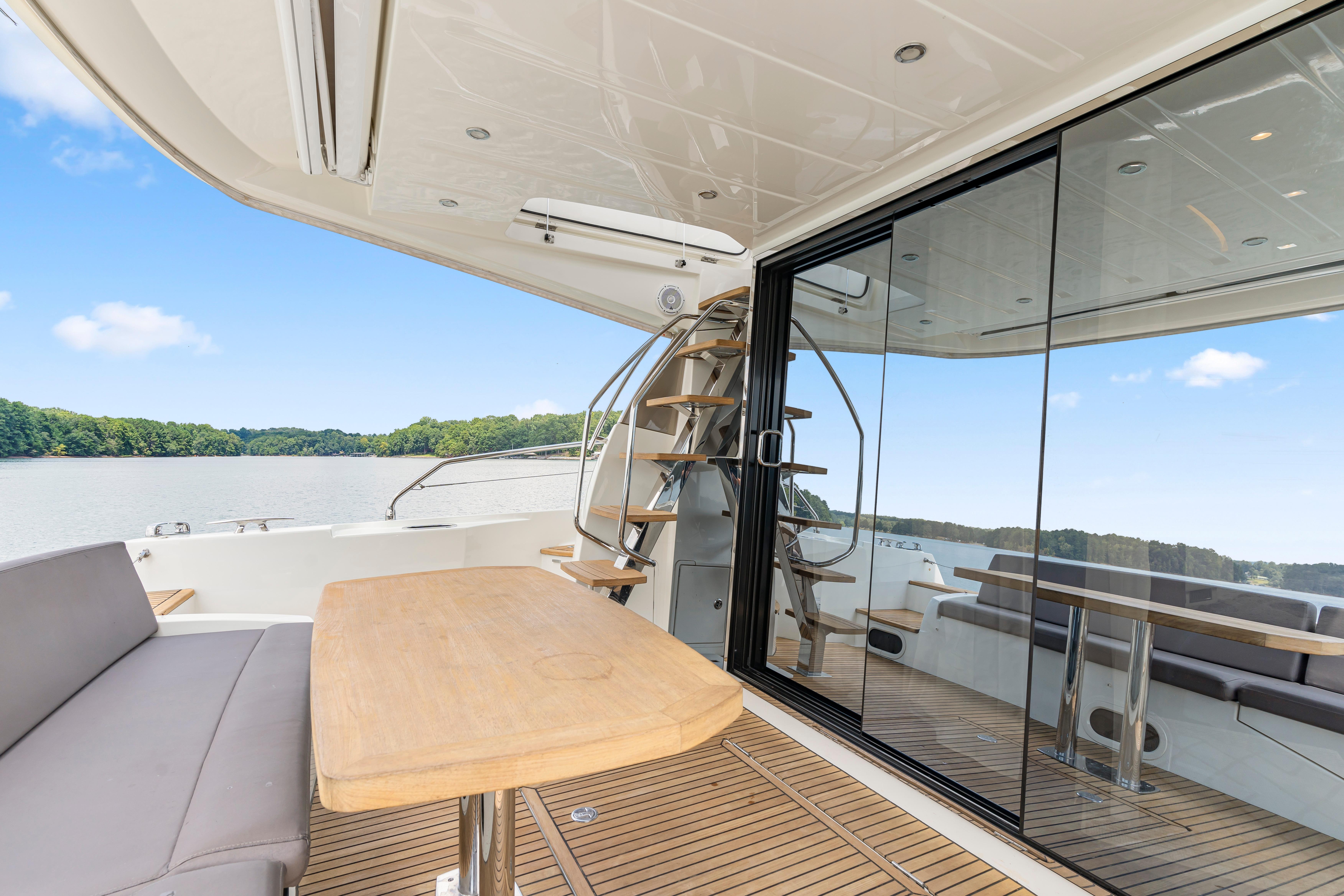 Luxurious 2017 Prestige 500 yacht with spacious deck, elegant seating, and scenic water views.