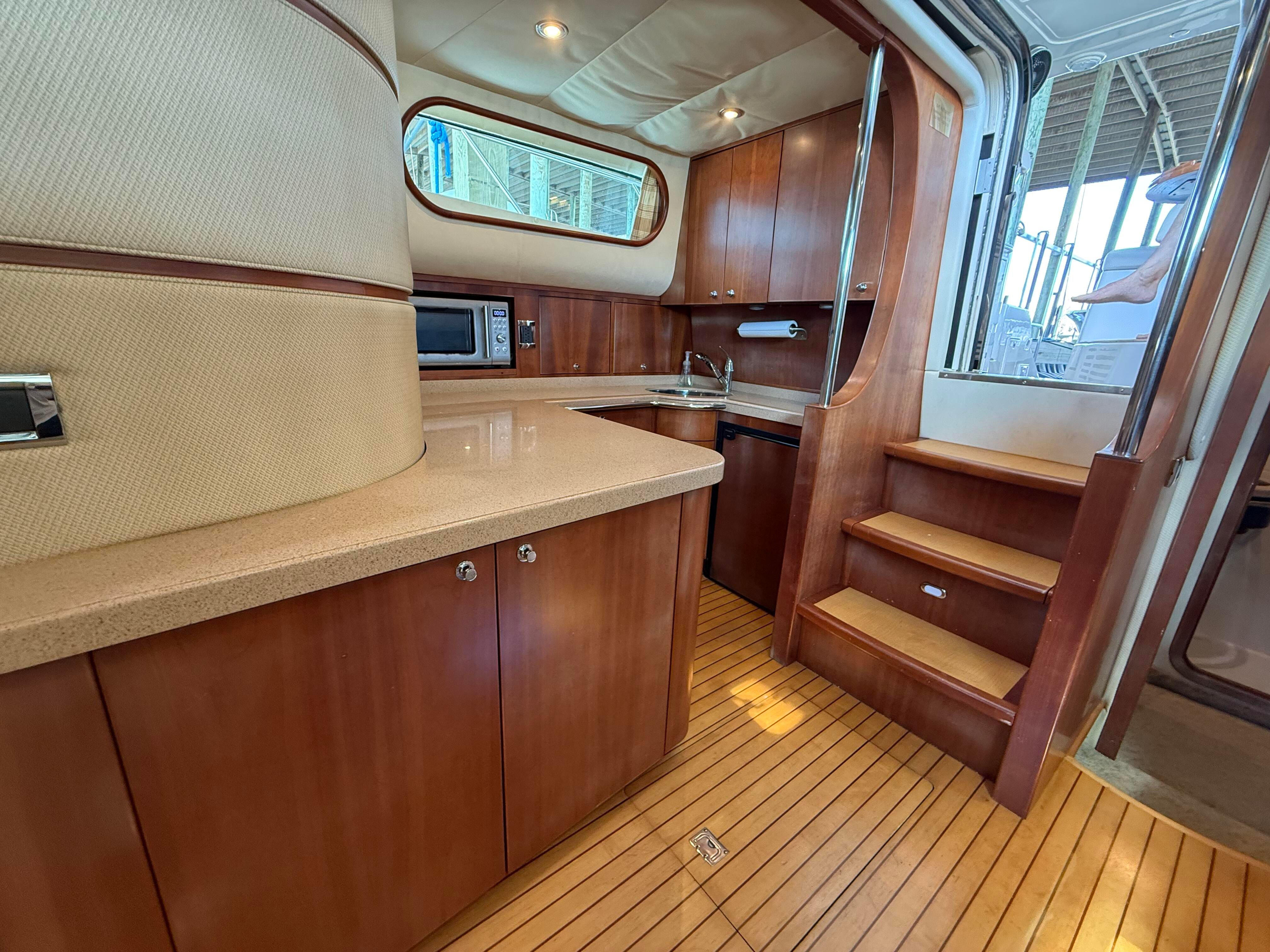 Interior of the 2007 Chris-Craft Roamer 40 with wood flooring and modern kitchen.
