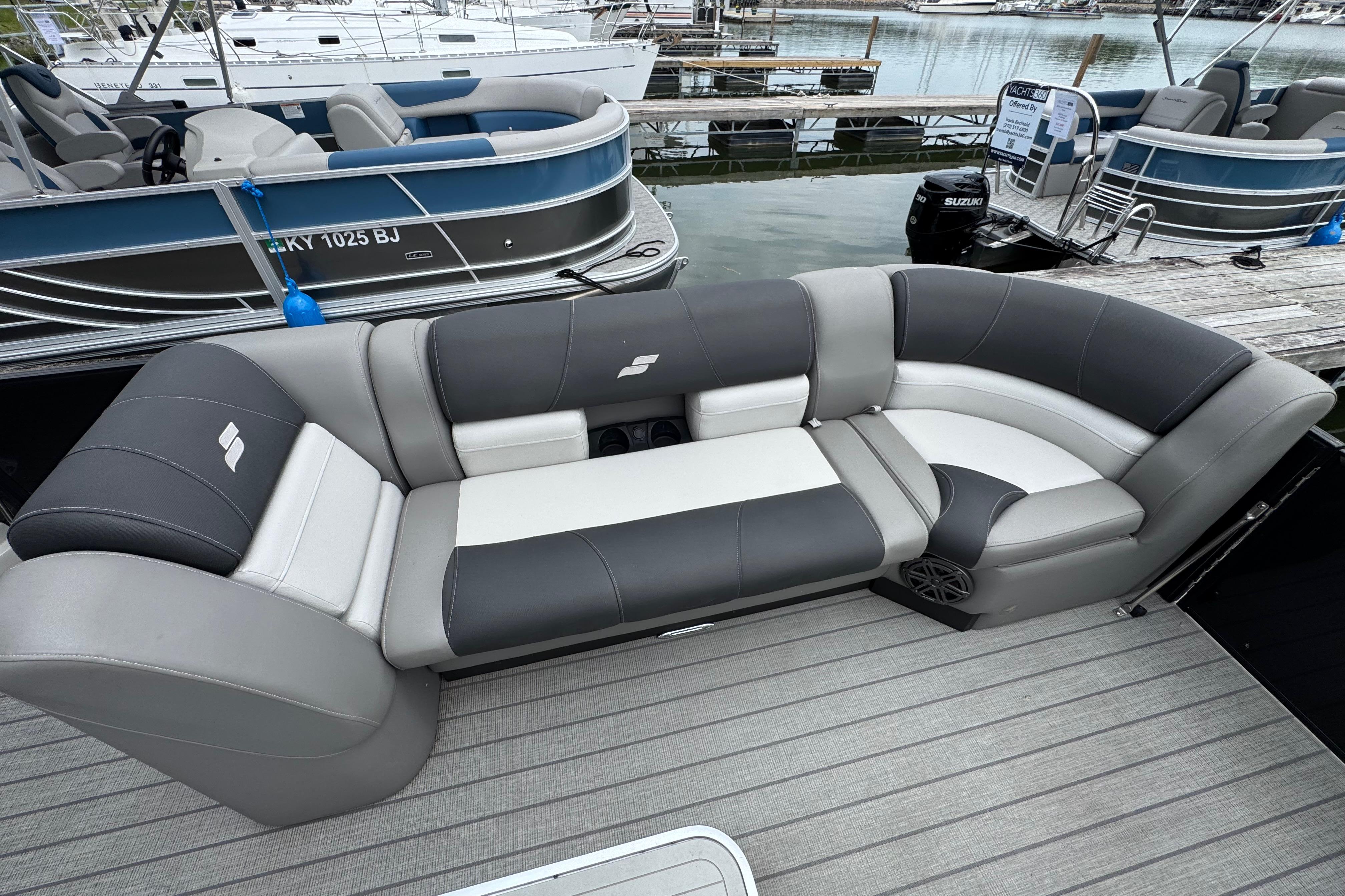 2023 Starcraft MX 25 DL DH pontoon boat with luxurious seating at a marina.