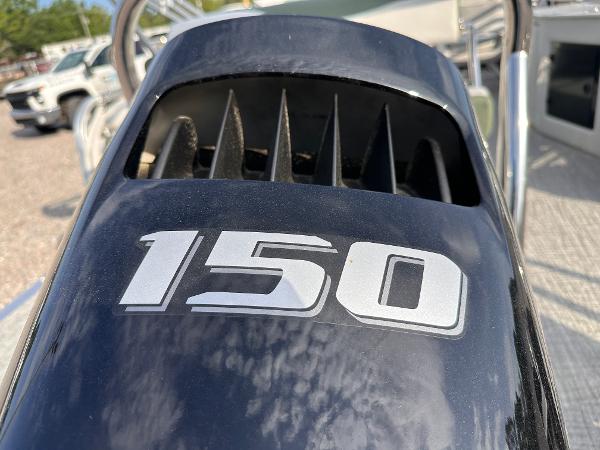 Outboard motor with "150" label on a 2025 Tahoe Pontoon LTZ Cruise Rear Bench.