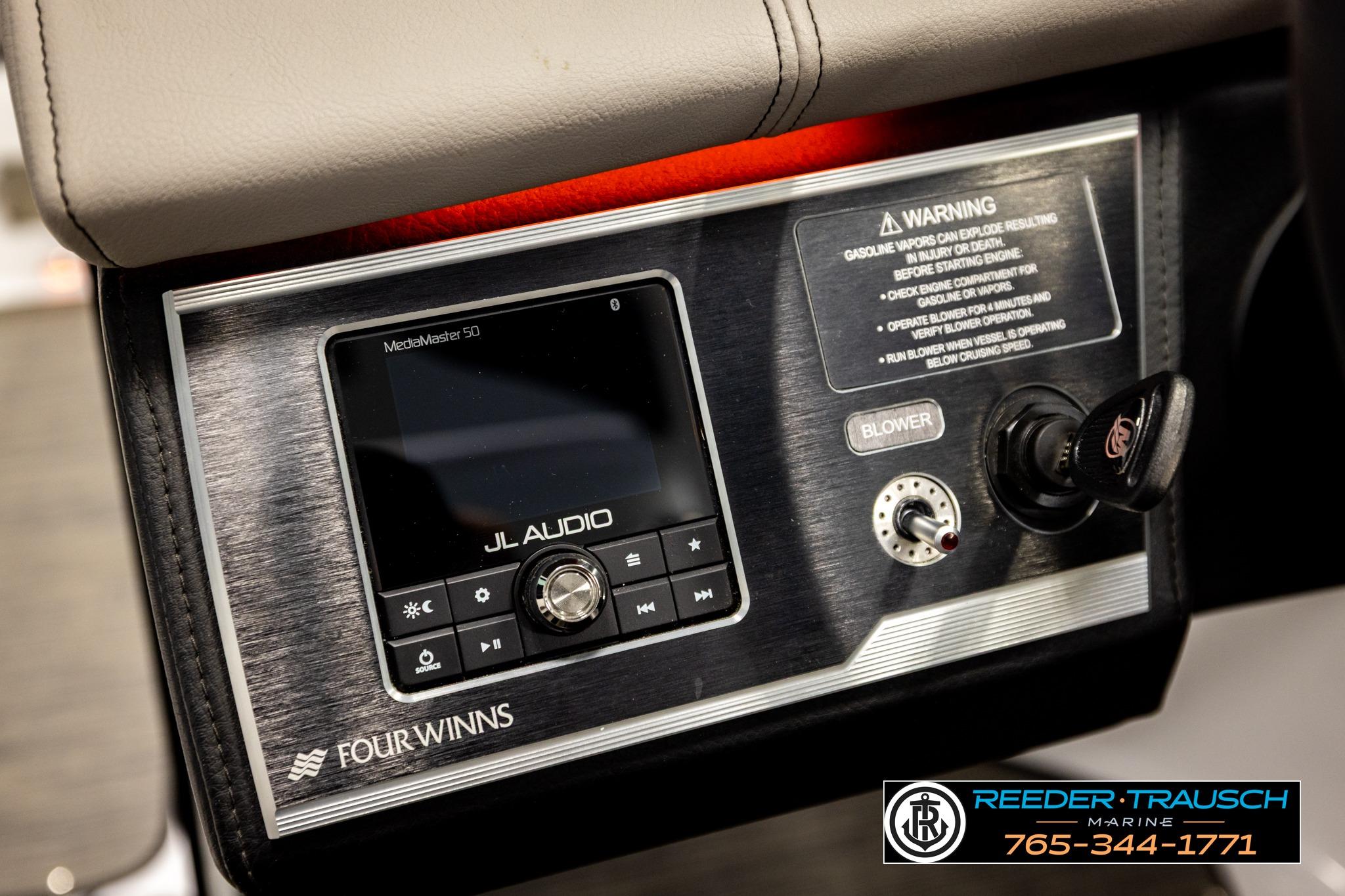 2024 FOURWINNS HD5 Surf boat dashboard with JL Audio system and warning label.