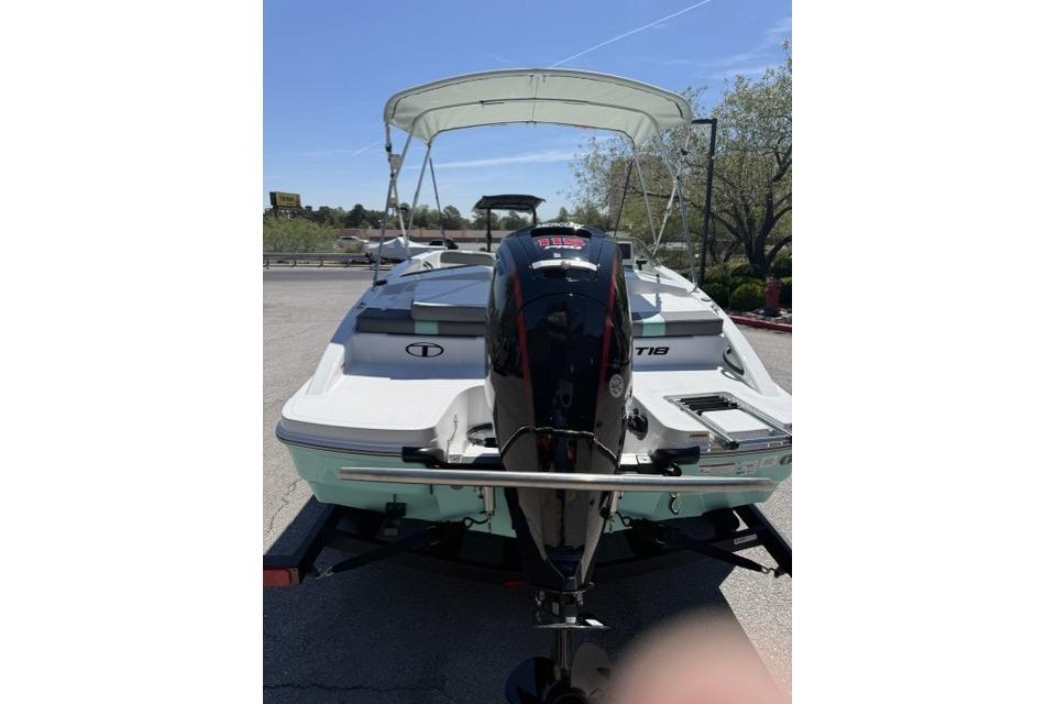 2026 Tahoe T18 boat with canopy and outboard motor on trailer.