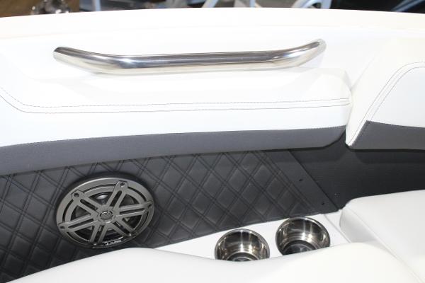 Interior of 2025 Cobalt R6 boat with speaker, cup holders, and handrail.