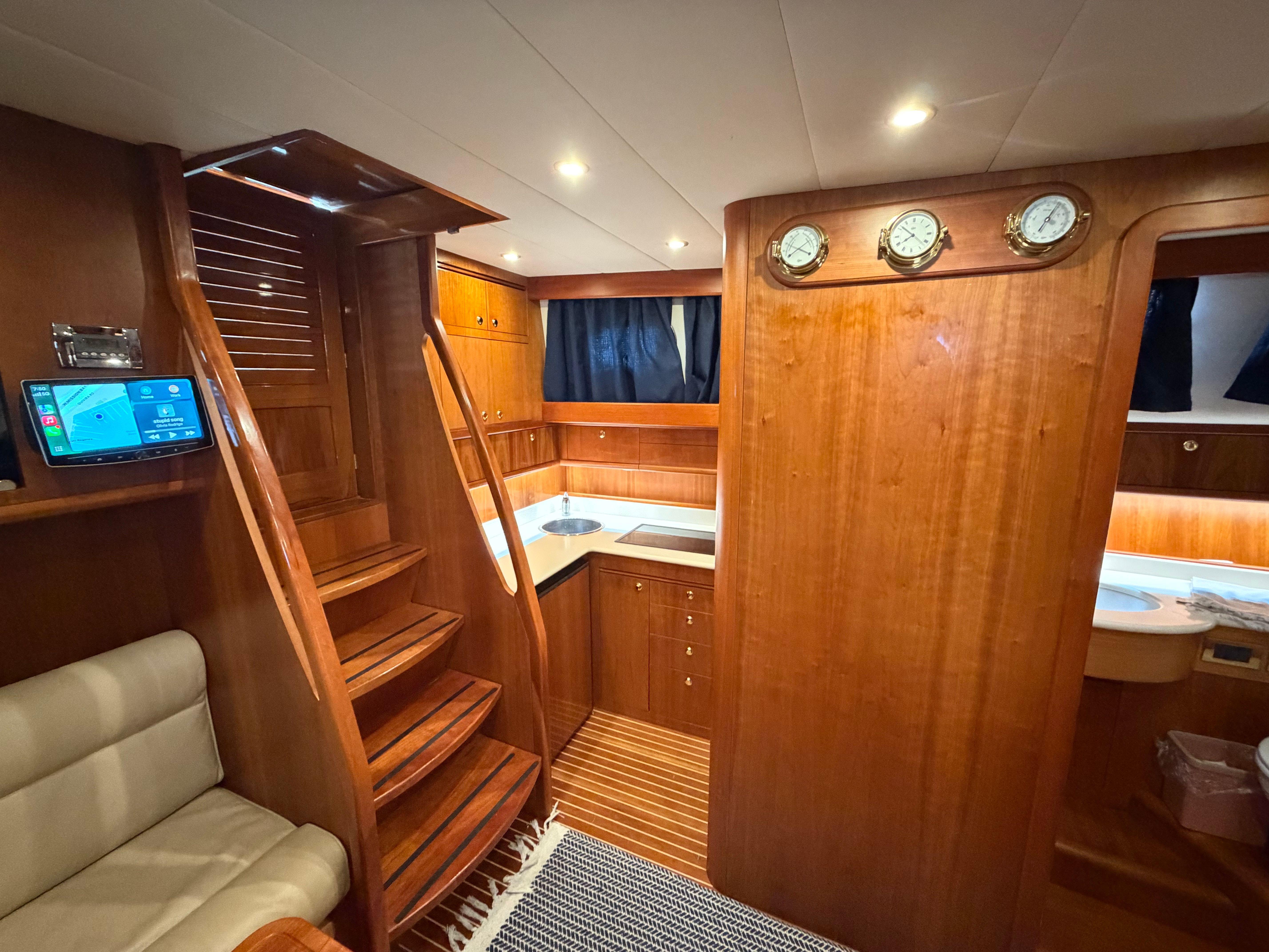 Interior of a 2003 Apreamare 11 with wooden finish and staircase.