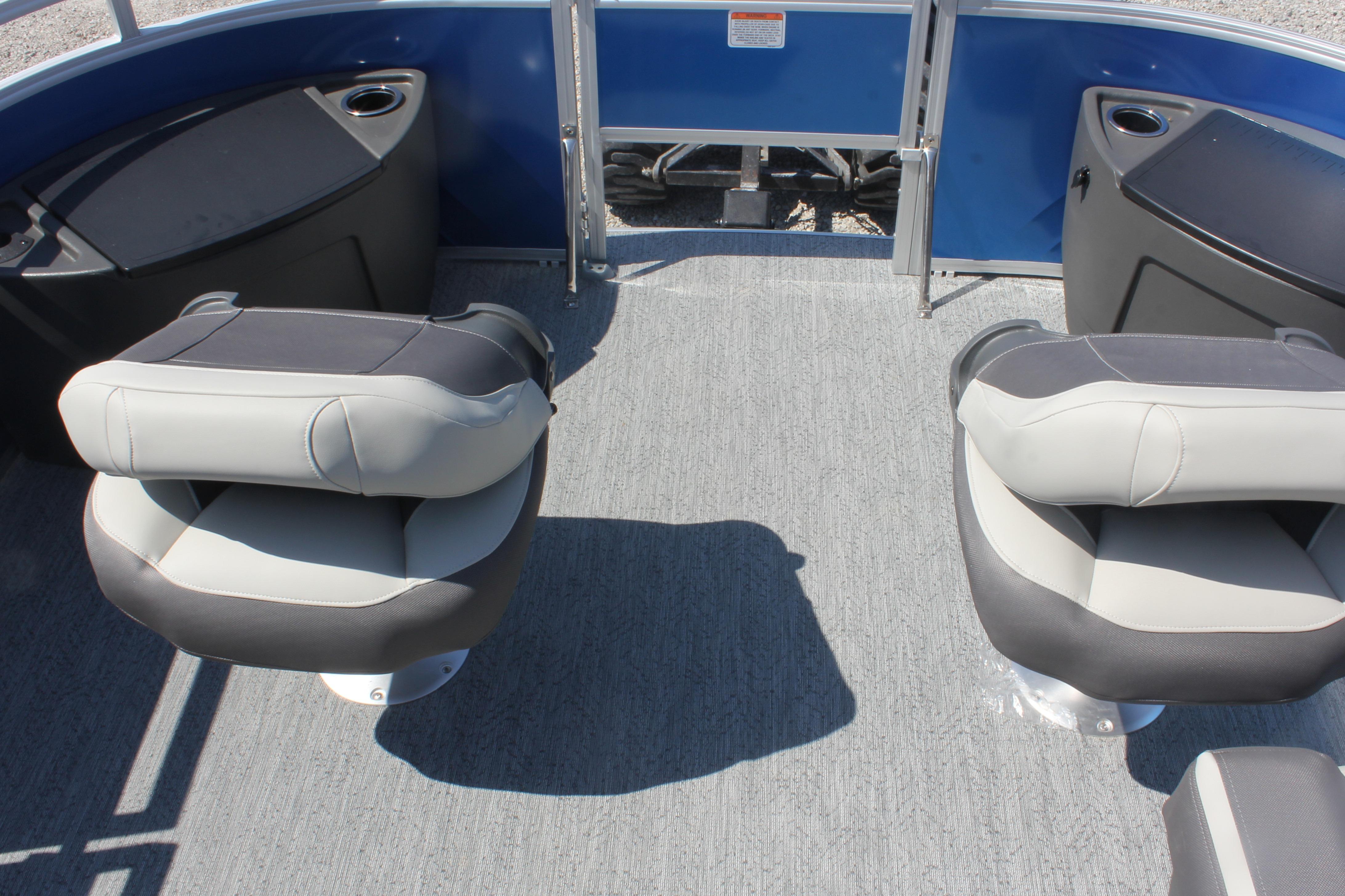 2026 Sun Tracker Fishin' Barge 20 DLX interior with swivel seats and cup holders.