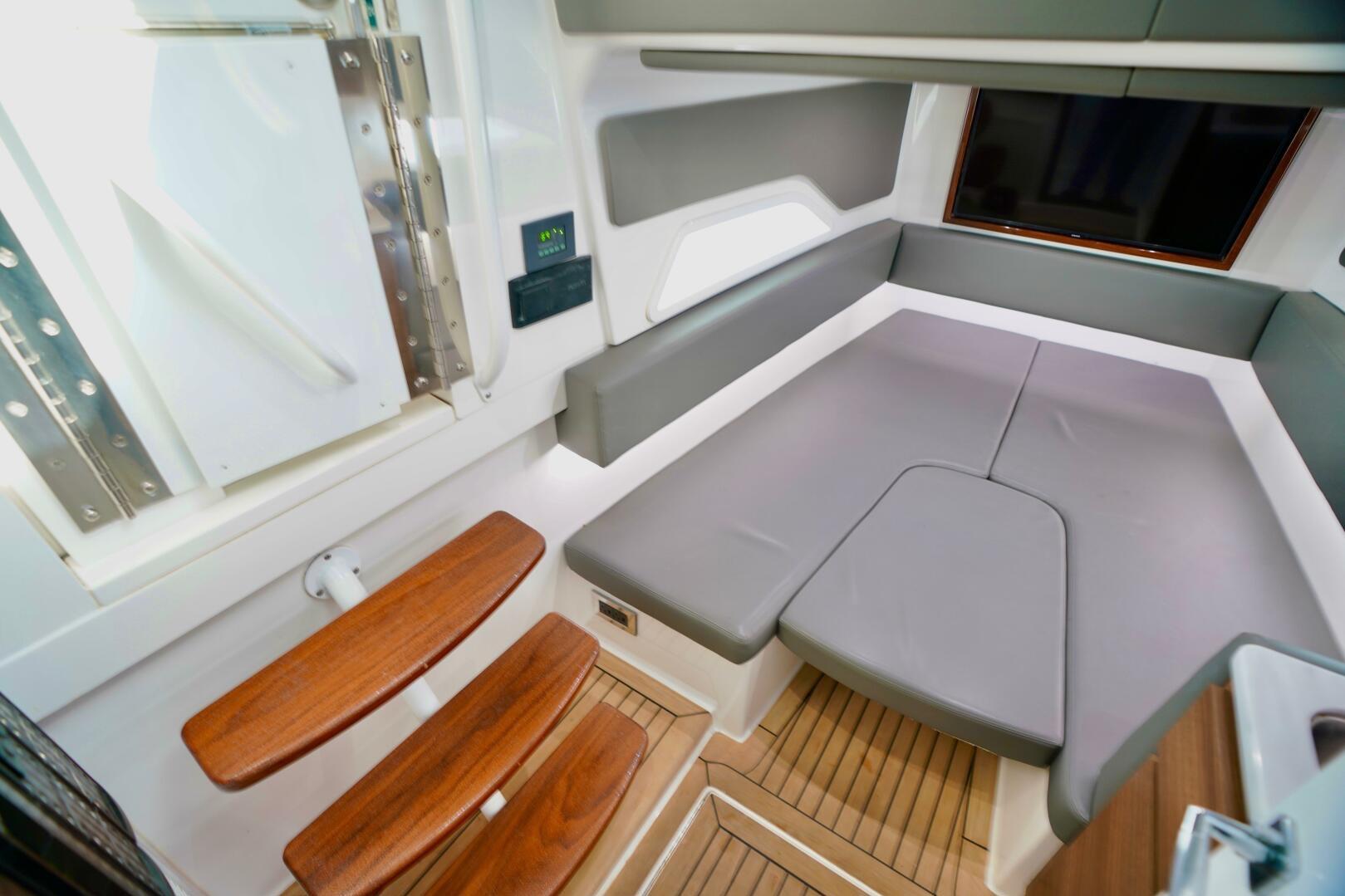 2021 Valhalla Boatworks V46 interior cabin with modern seating and wooden steps.