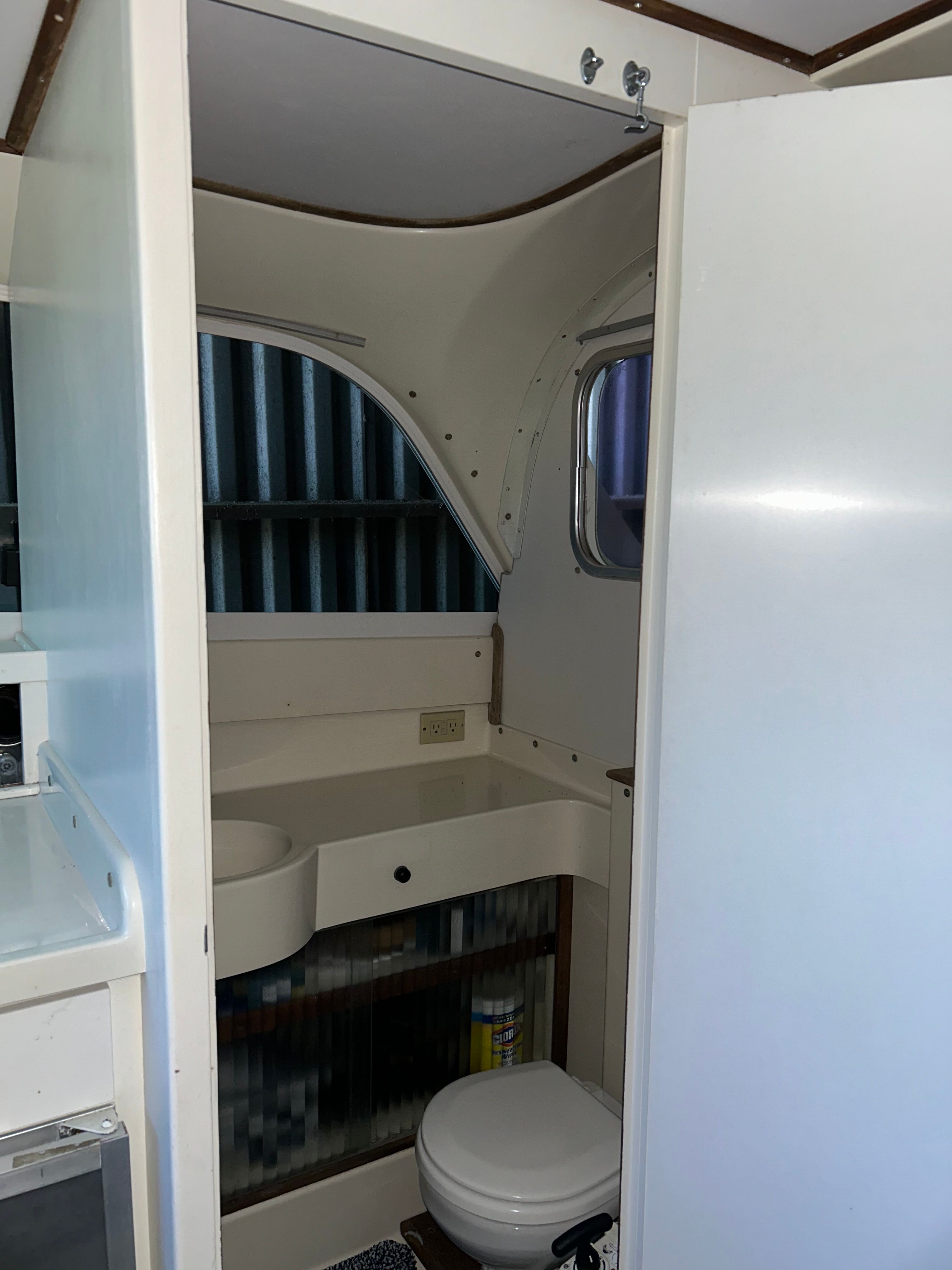 Interior of a 1970 Bertram Flybridge Cruiser with bathroom.