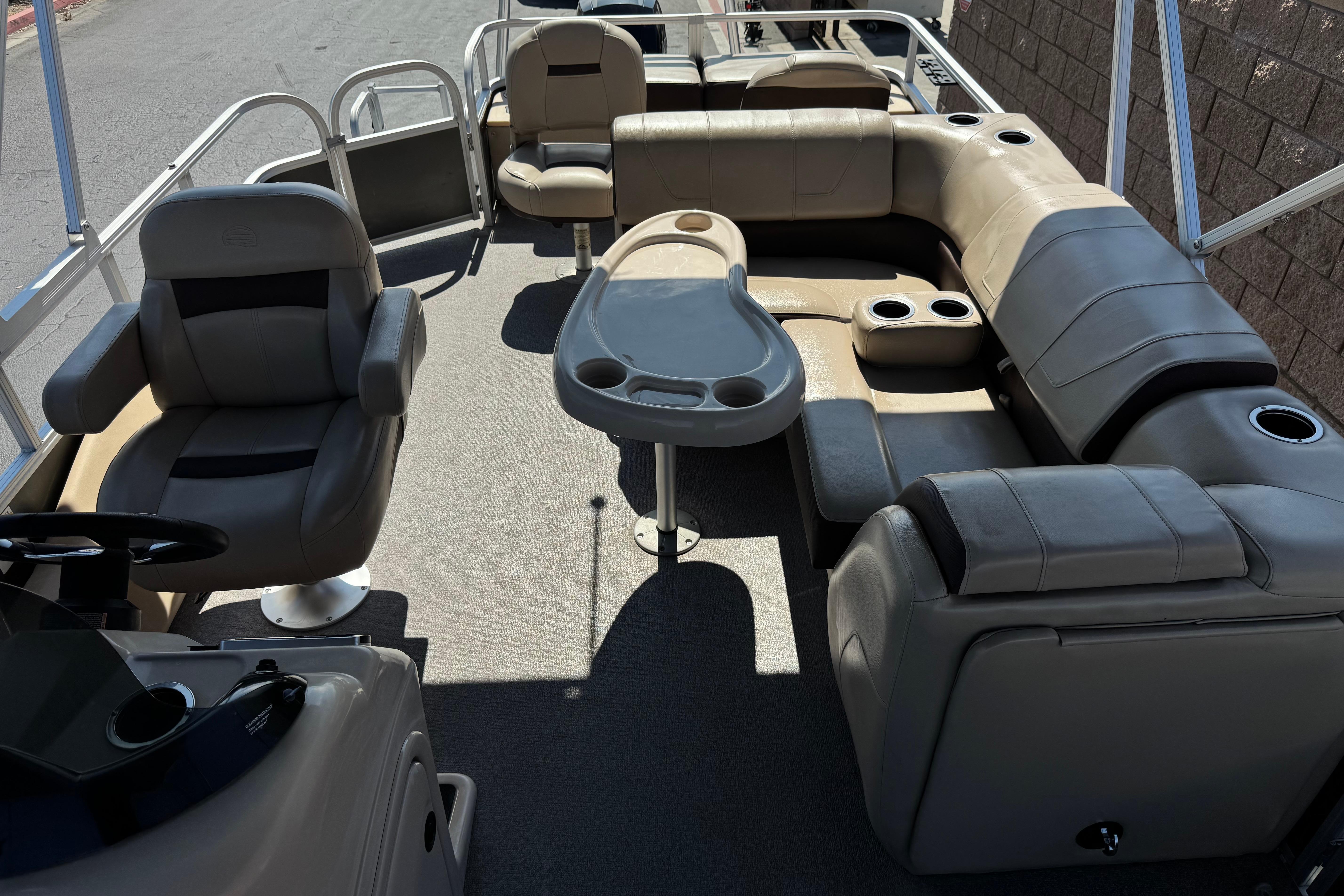 2018 Sun Tracker SportFish 22 DLX pontoon boat interior with seating and table.