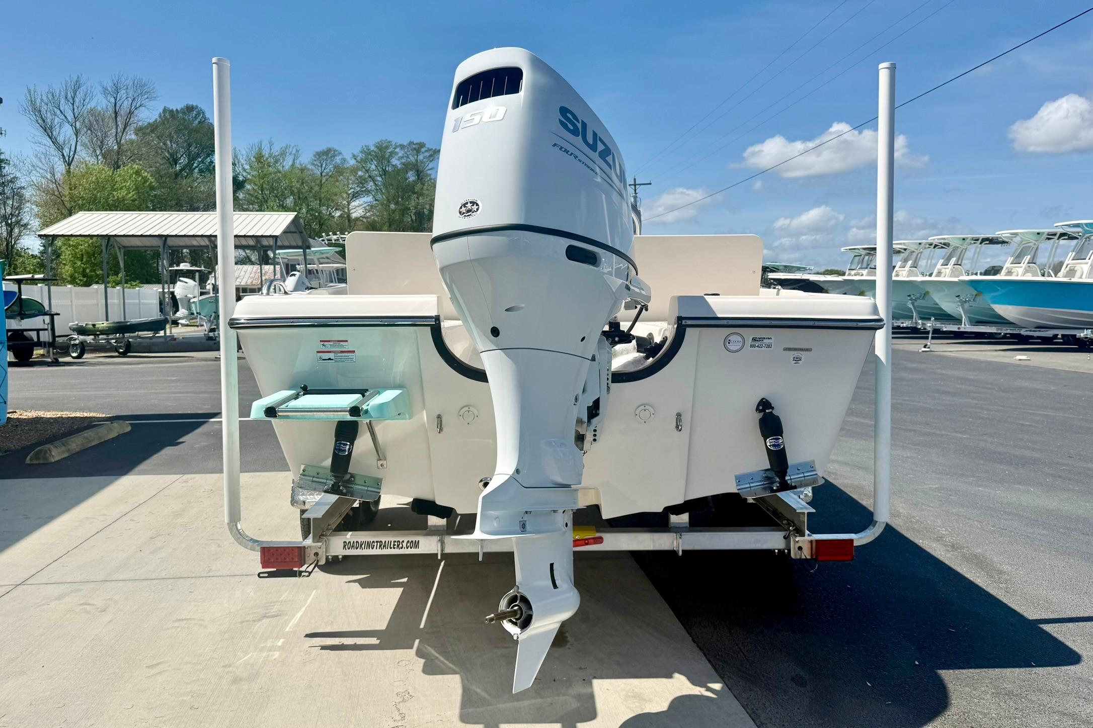 2026 Carolina Skiff 21 Ultra Elite boat with Suzuki outboard motor on trailer.