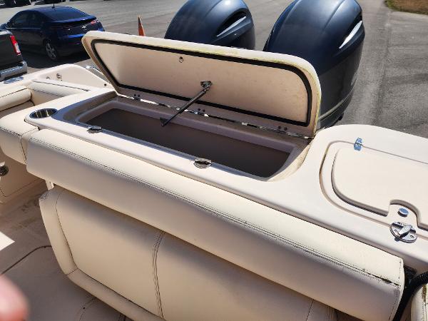 2015 Grady-White Freedom 275 boat with open storage compartment and dual engines.