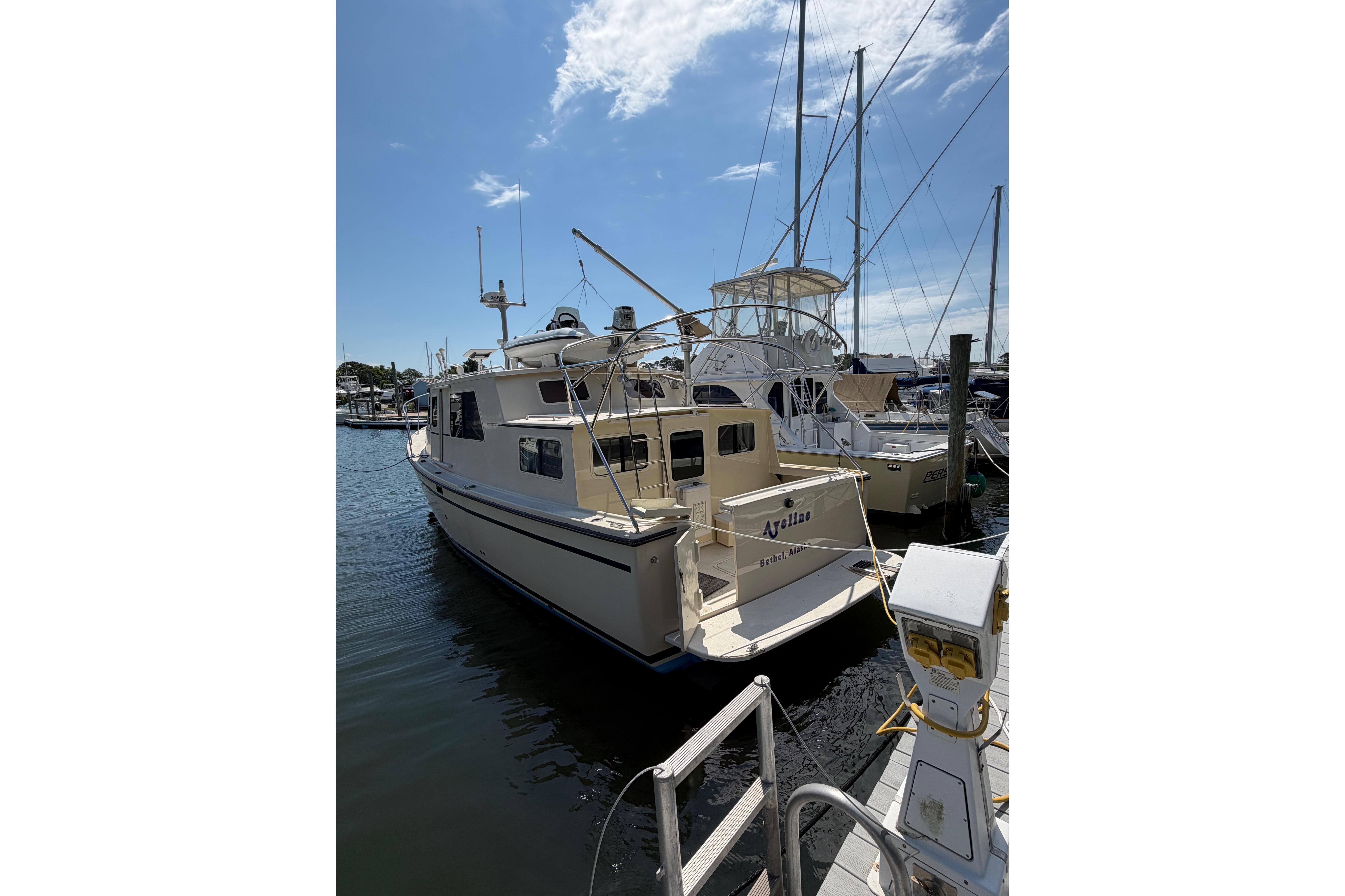 1997 Rosborough Trawler docked at marina under clear blue sky.