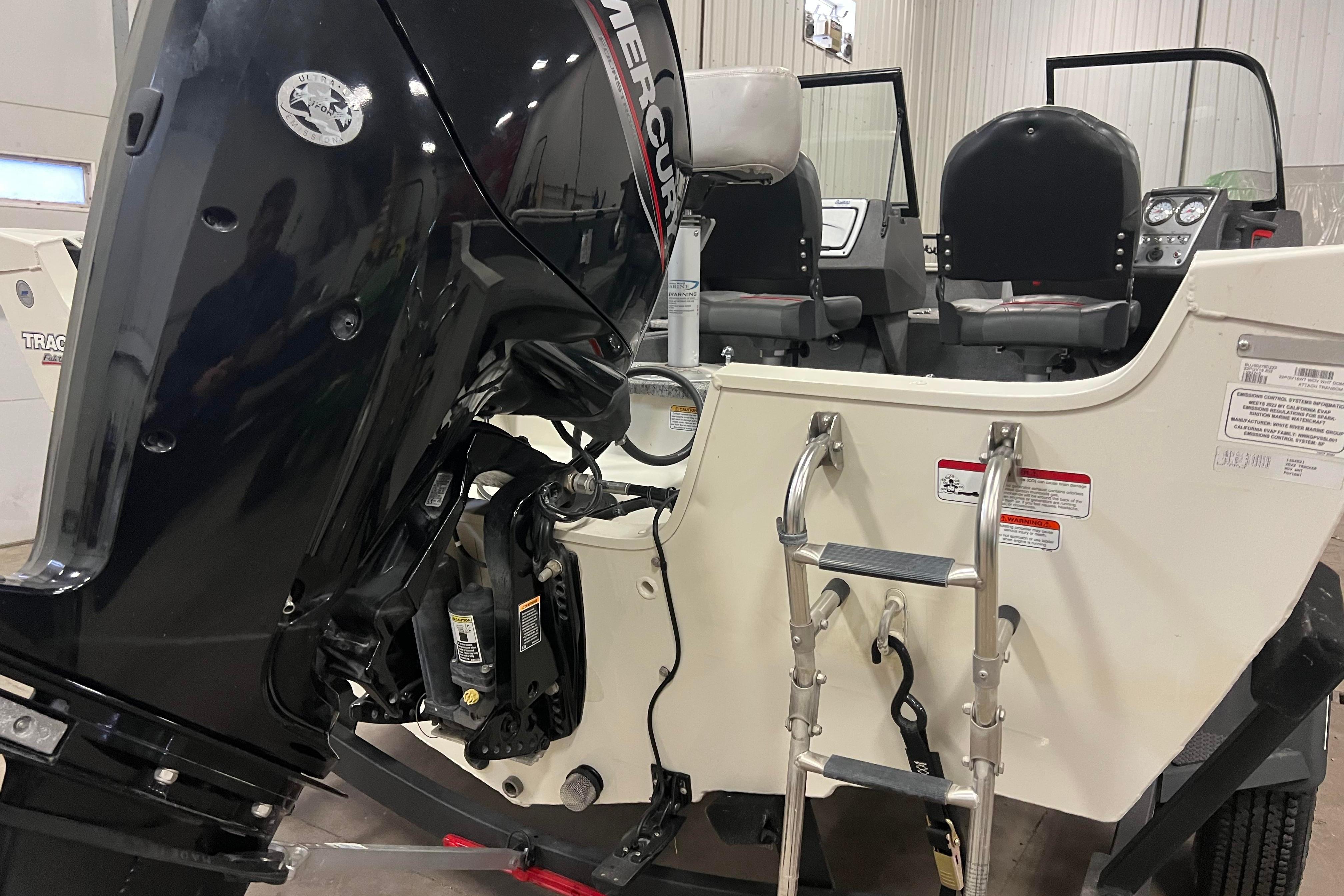 2022 Tracker Pro Guide V-16 WT boat with Mercury outboard motor and ladder.