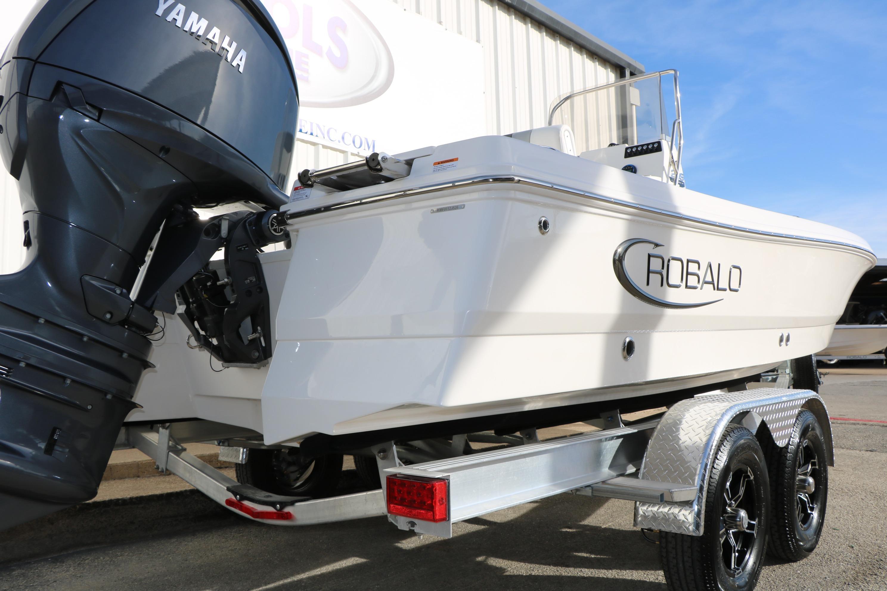 2026 Robalo 206 Cayman boat with Yamaha engine on trailer, outdoor display.