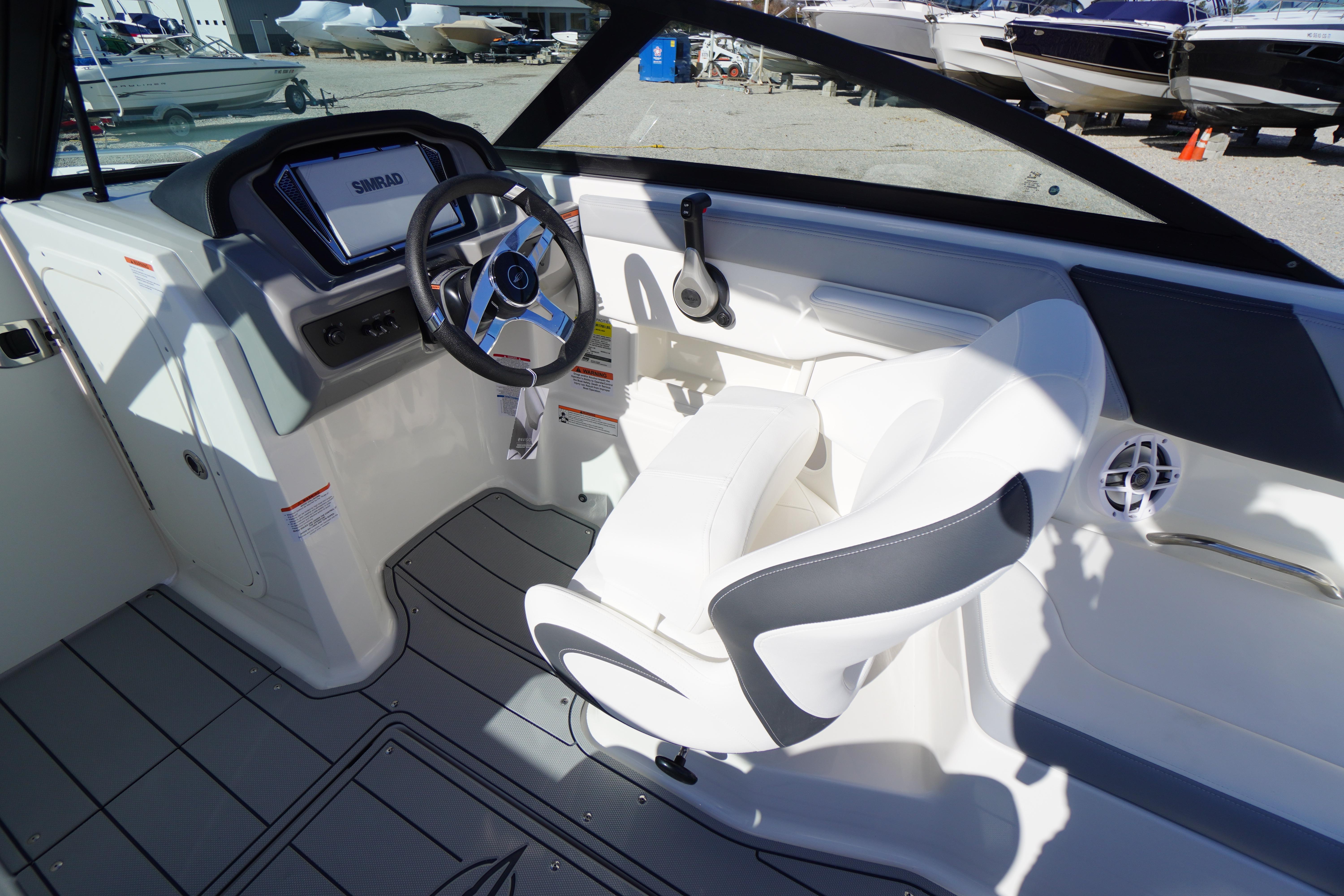 Interior of 2026 Chaparral 23 SSi OB boat with steering wheel and seating.