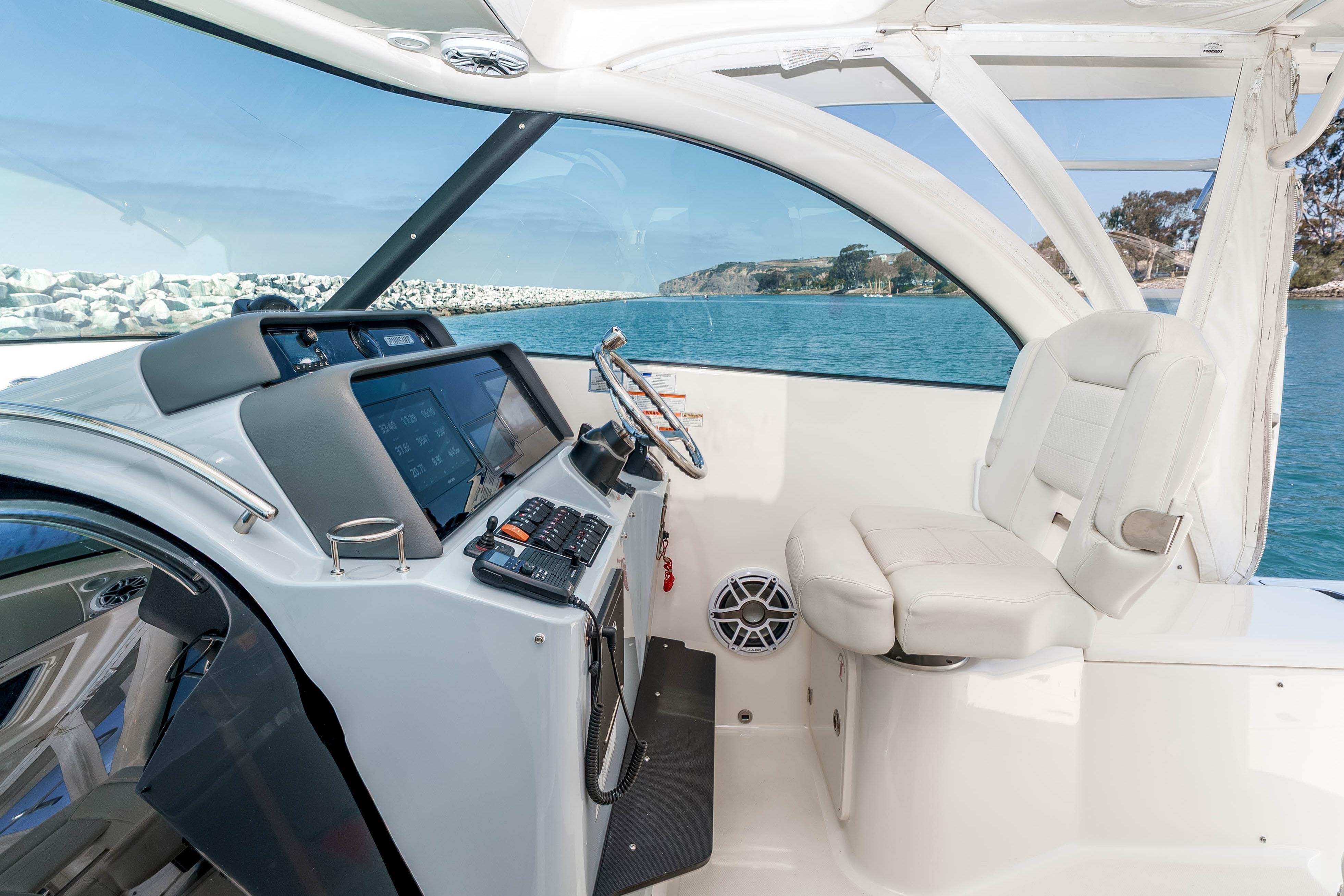 2022 Pursuit OS 385 Offshore helm with modern controls and ocean view.