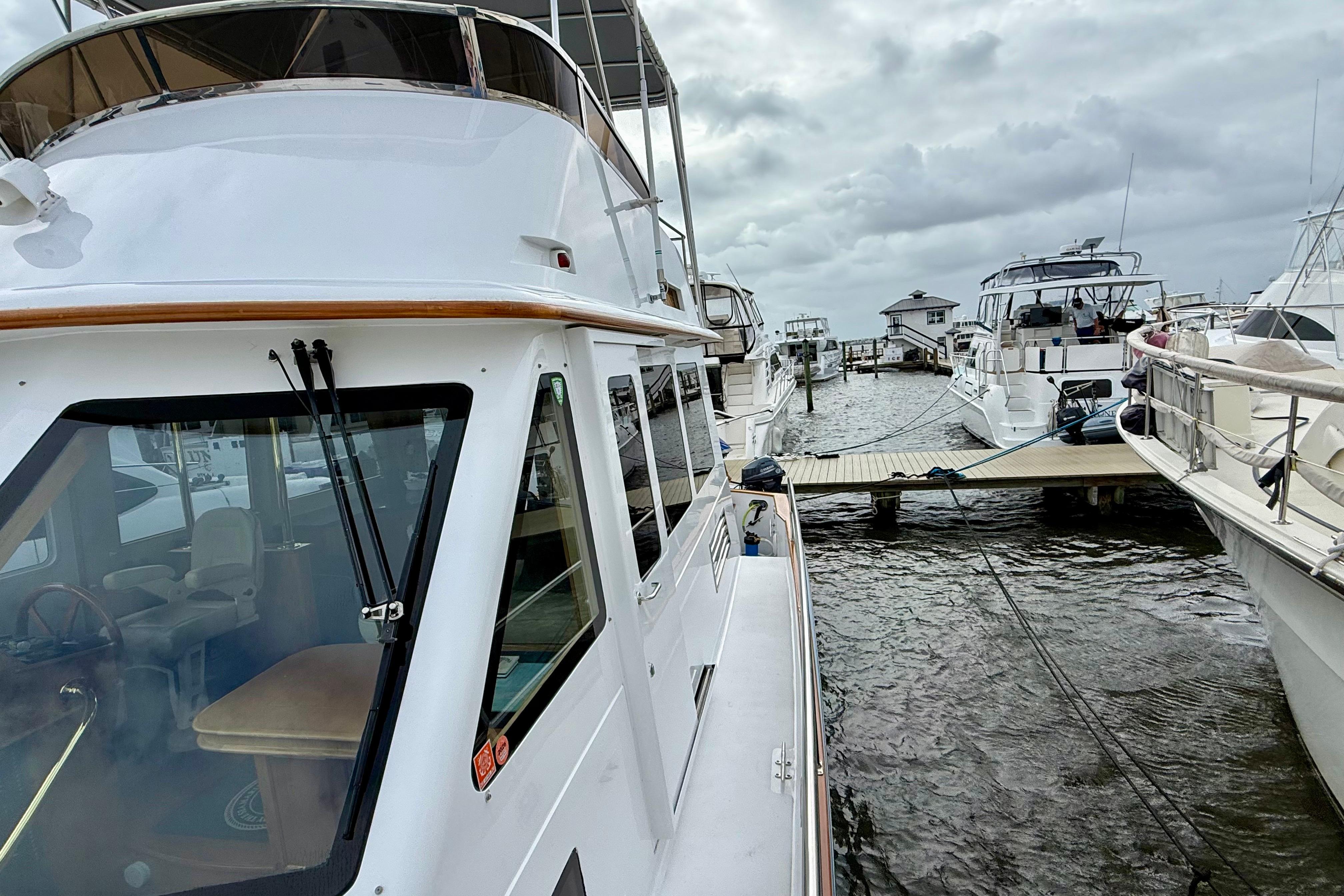 Legacy 52 yacht docked at marina, cloudy sky, 2002 model.