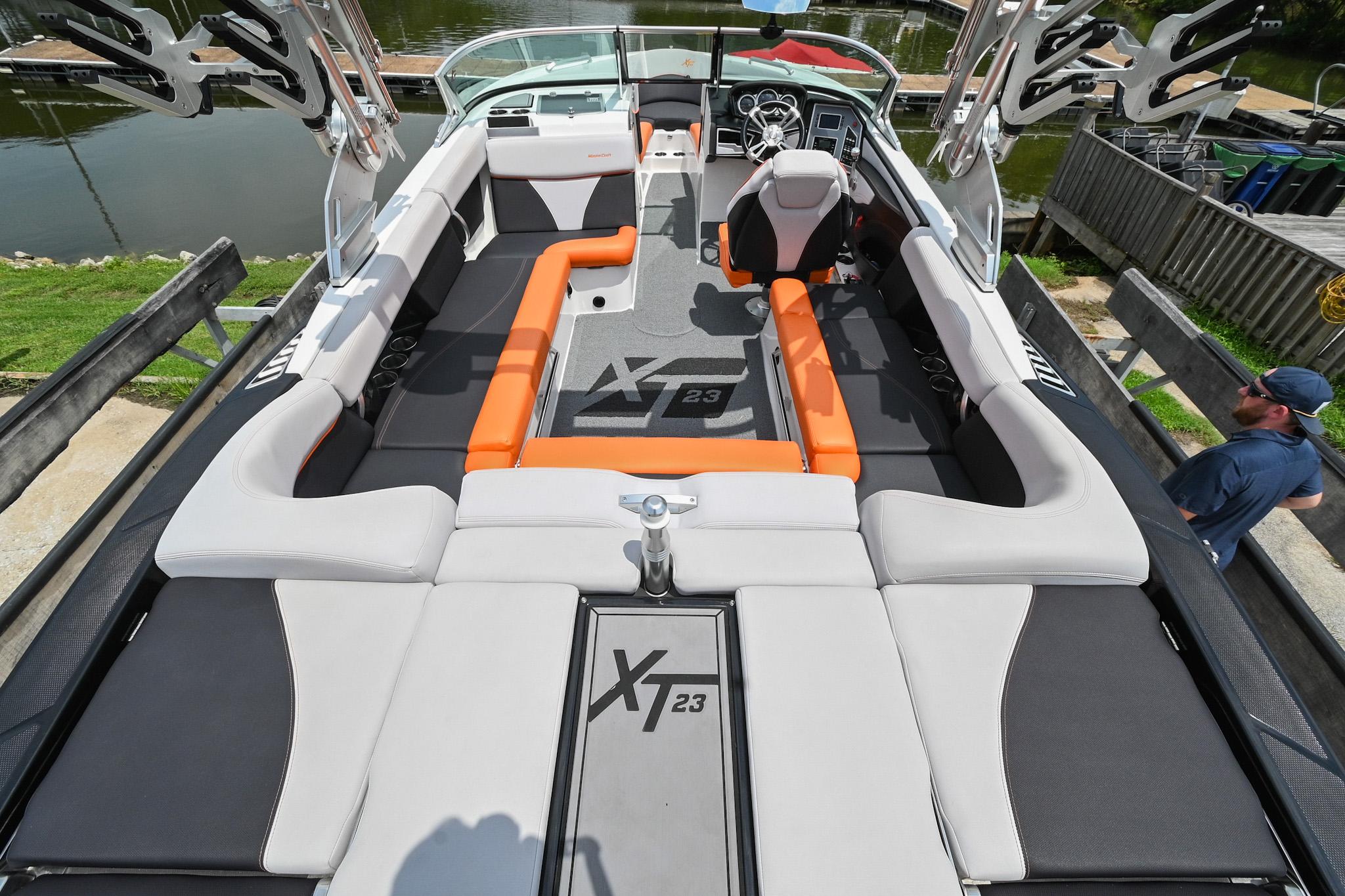 2018 MasterCraft XT23 boat interior with orange and gray seating, sleek design.