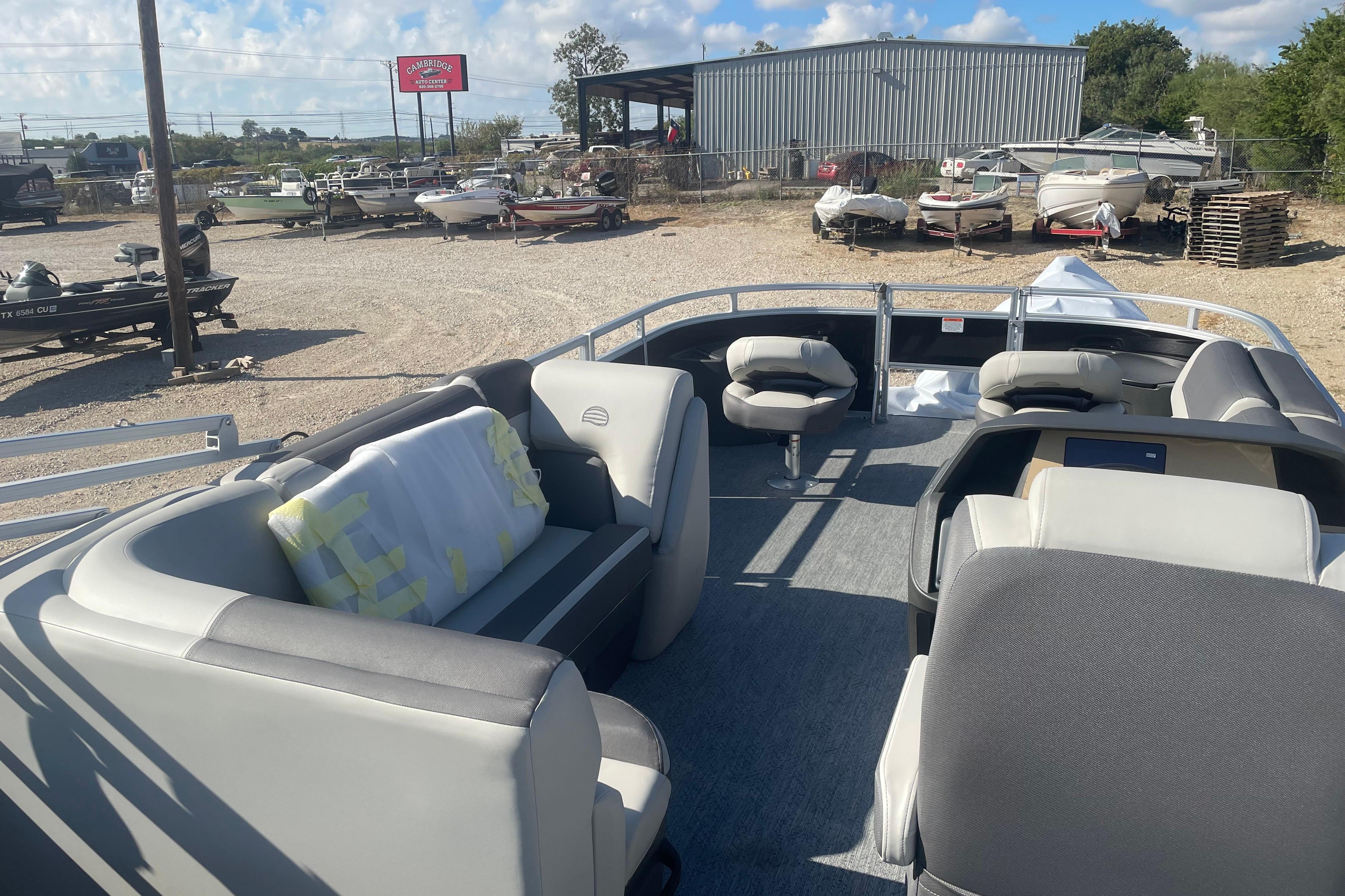 2026 Sun Tracker Fishin' Barge 20 DLX pontoon boat interior at a dealership.