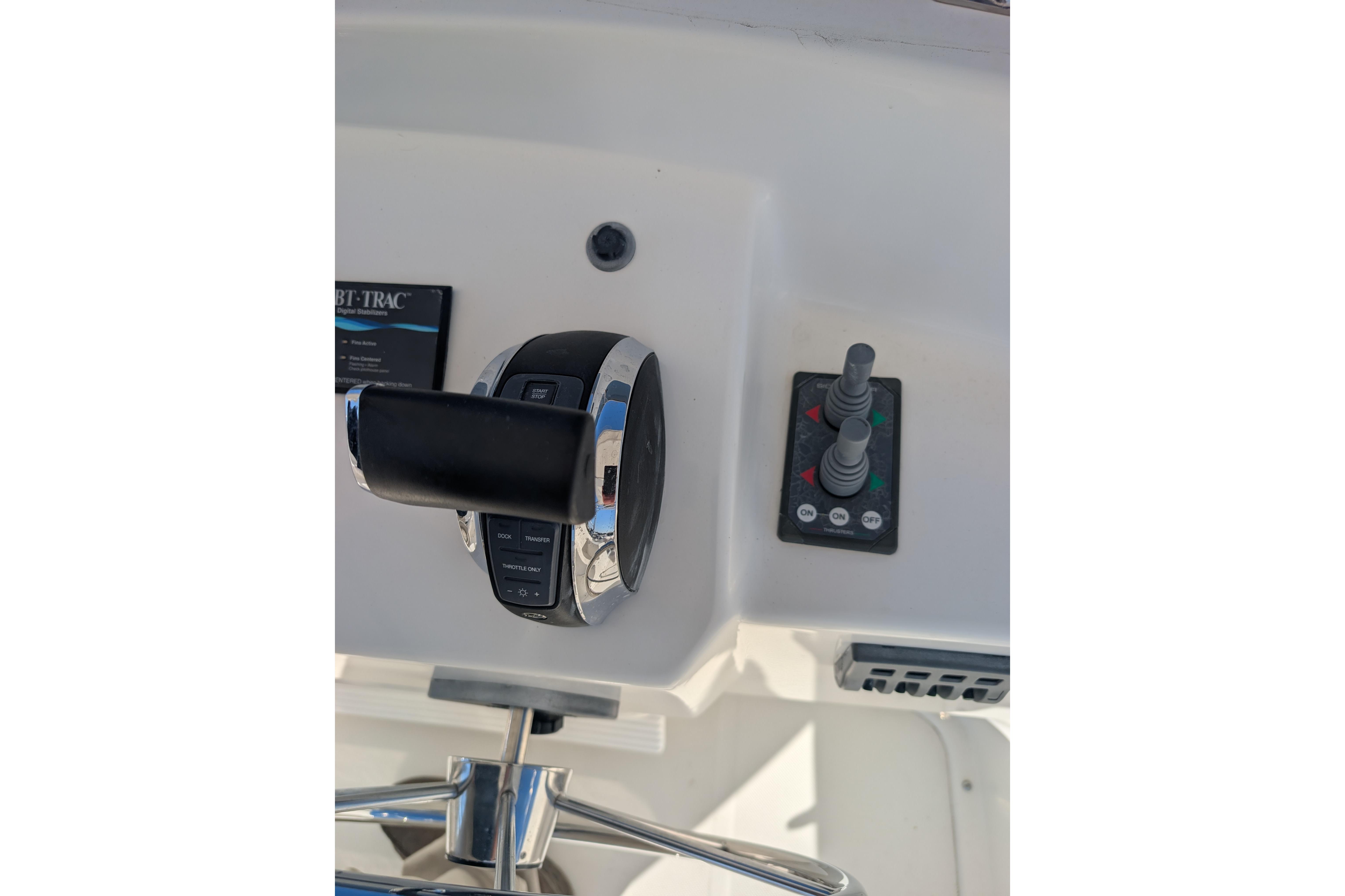 Control panel of a 2015 American Tug 435 boat, featuring throttle and joystick controls.