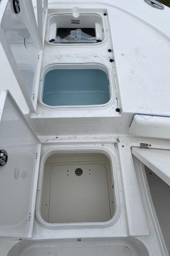2026 Robalo 246 Cayman boat storage compartments, open and empty, showcasing spacious design.