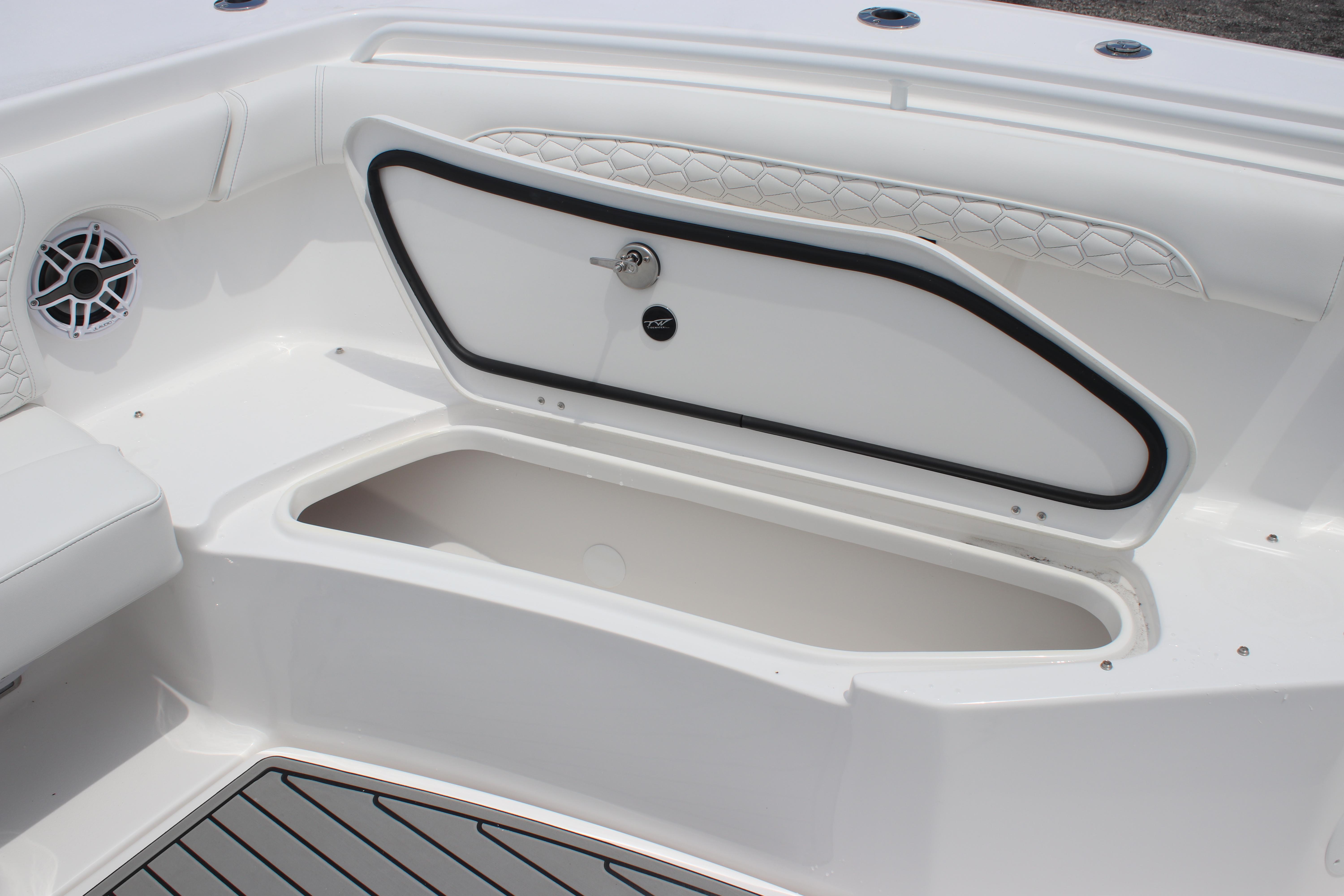 2026 Tidewater 272 LXF boat storage compartment with sleek design and speaker detail.