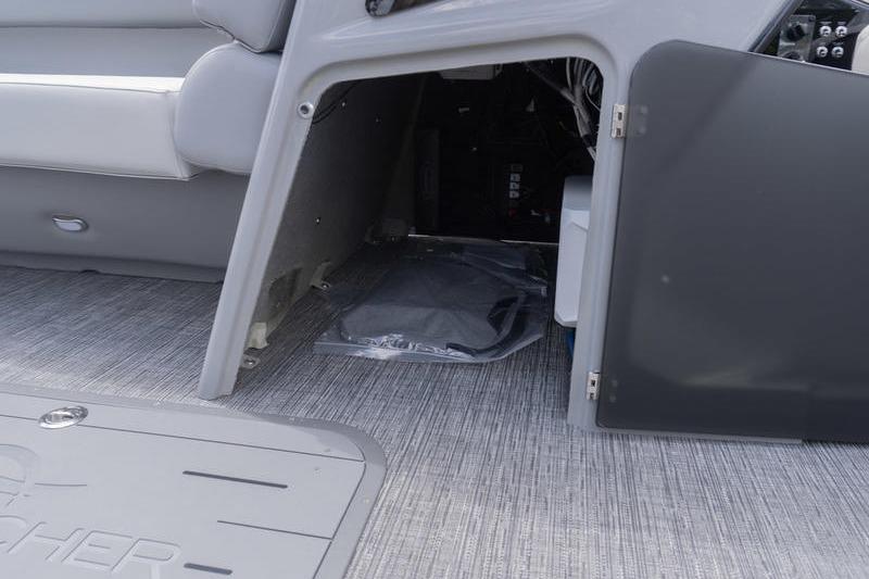 2026 SunCatcher Elite 326 SL boat interior storage compartment with open door.