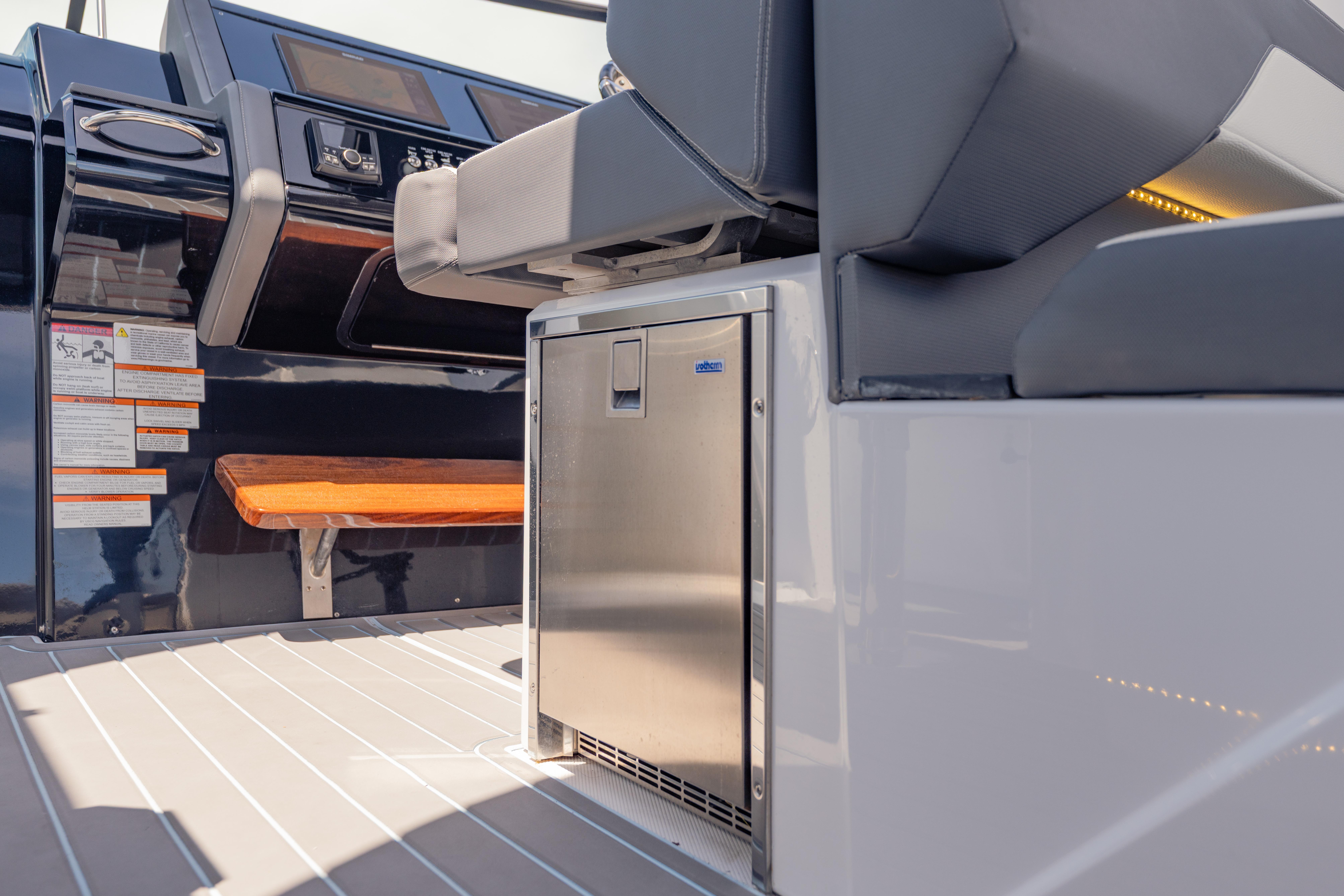 2021 Cruisers Yachts 38 GLS interior with seating and stainless steel mini-fridge.