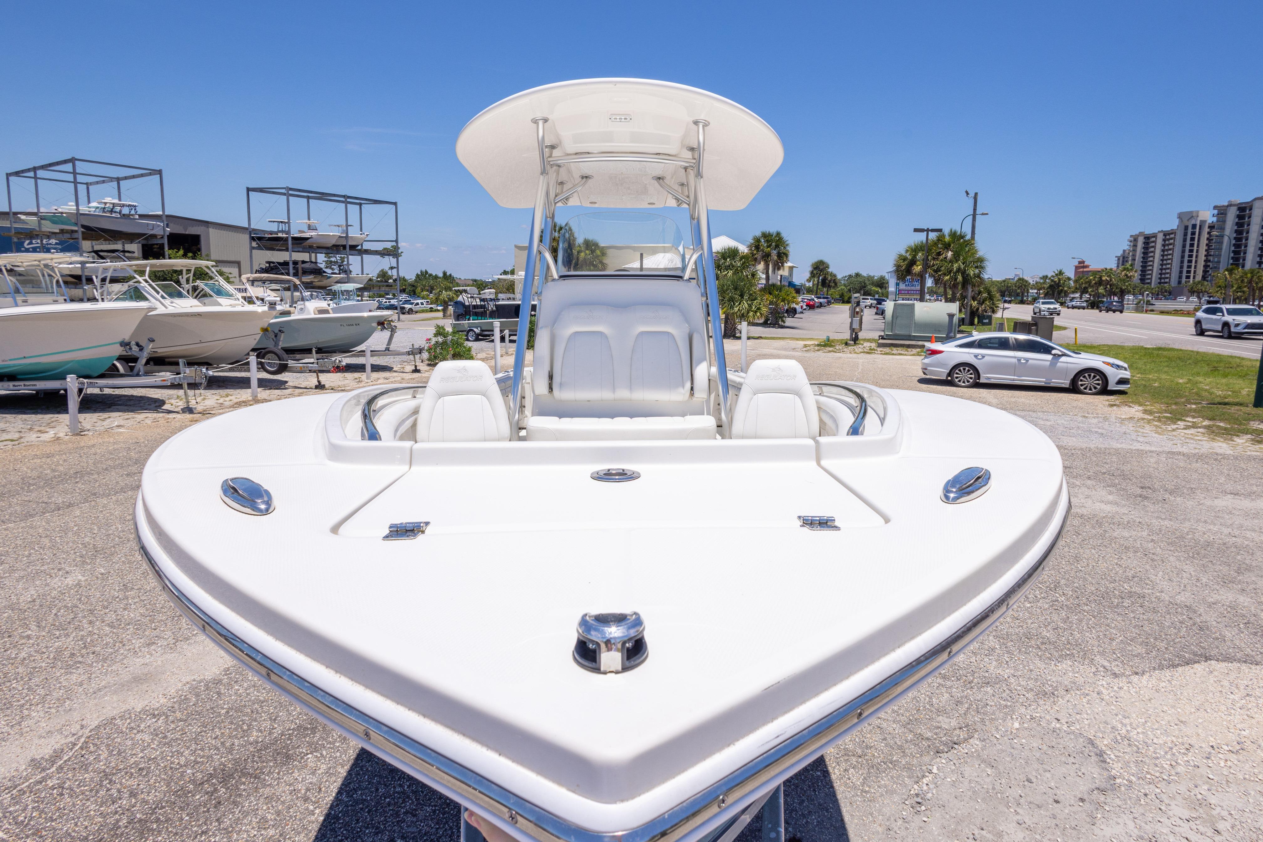 2019 Regulator 23 Center Console boat displayed in a marina under clear blue skies.