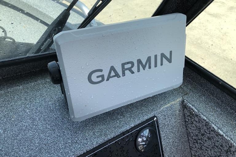 Garmin device on 2023 Alumaweld Talon 18 boat dashboard, with water droplets.