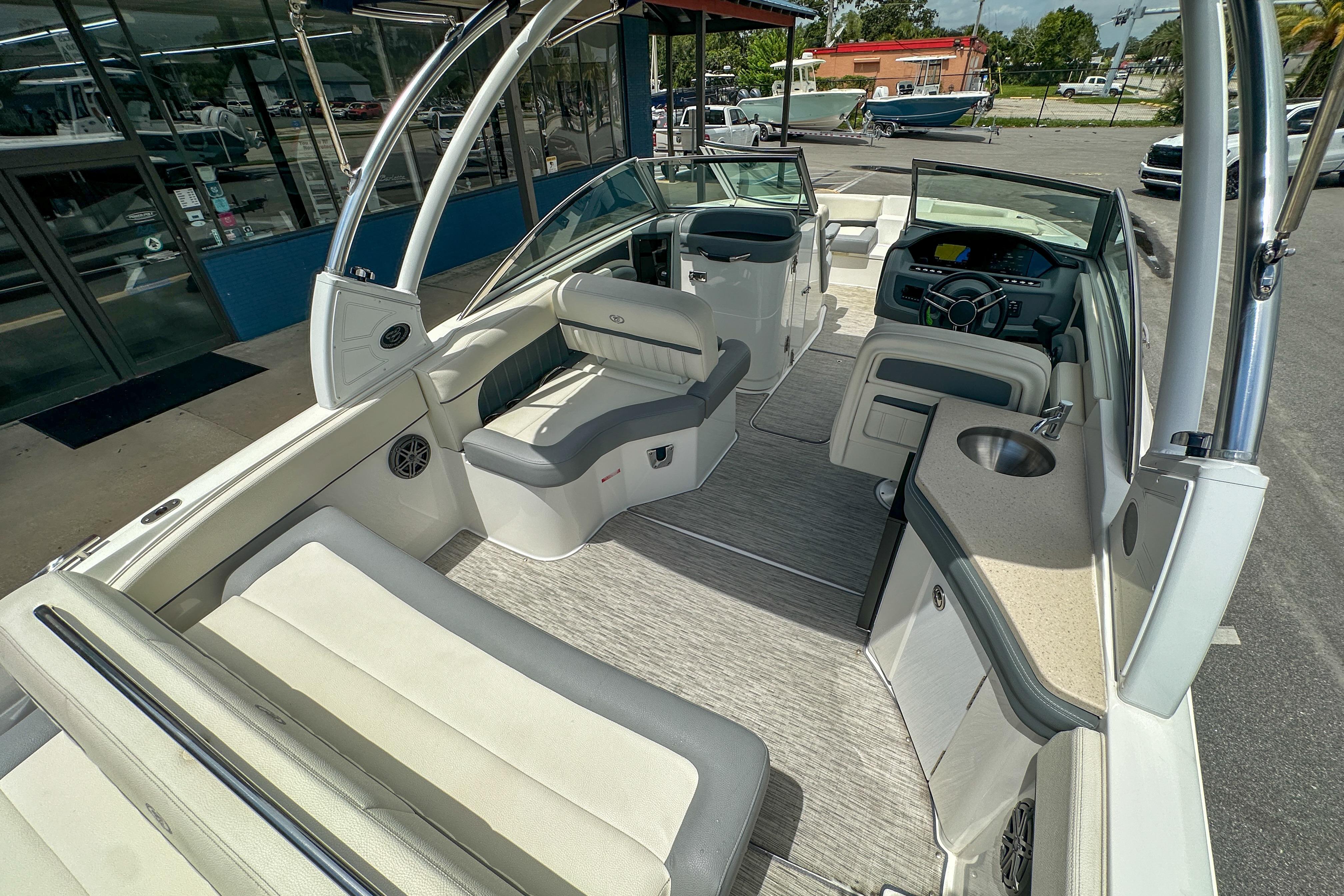 2022 Cobalt 25SC boat interior with seating, steering console, and sink.