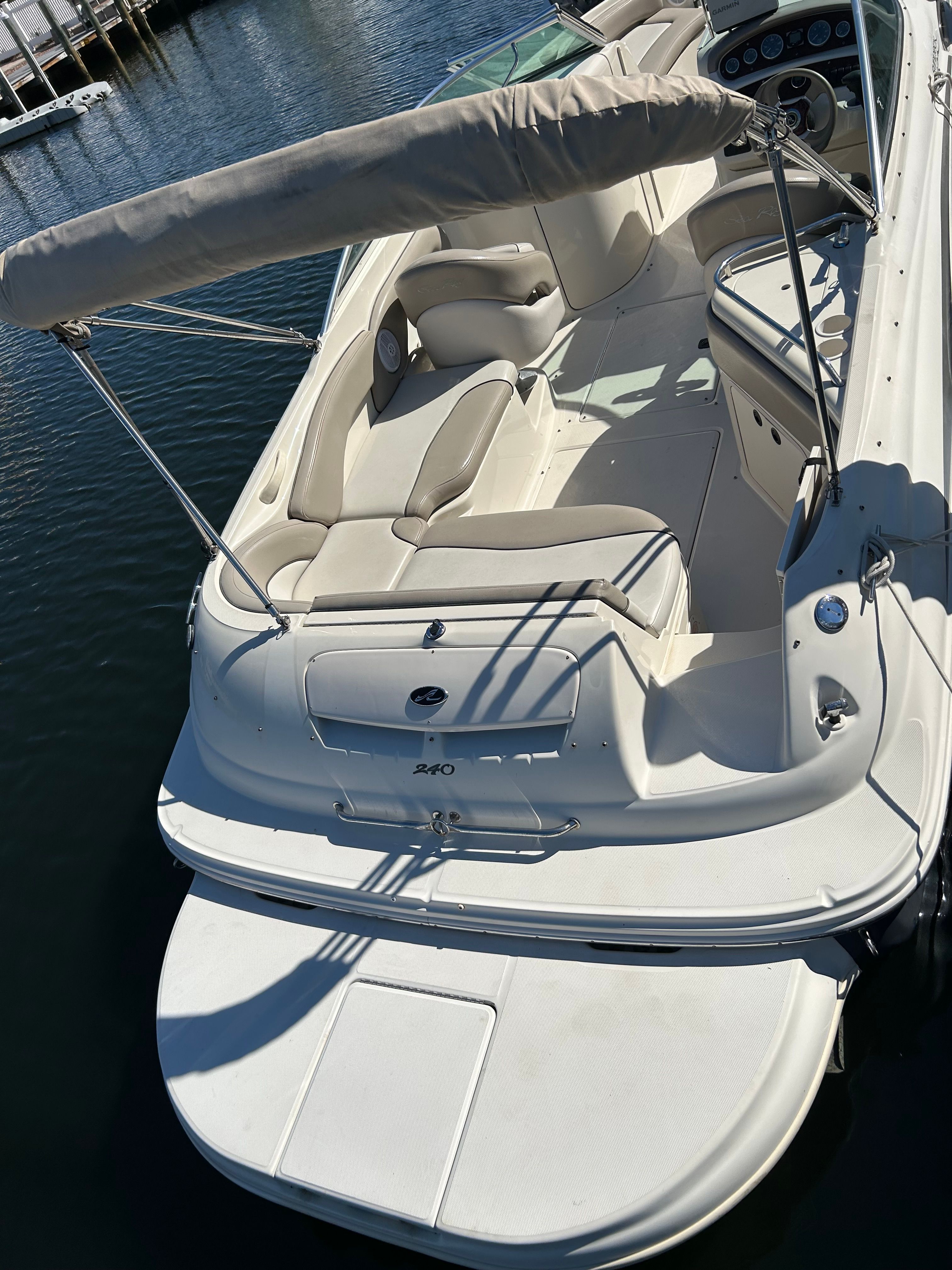2003 Sea Ray 240 Sundeck boat on water with sunshade.