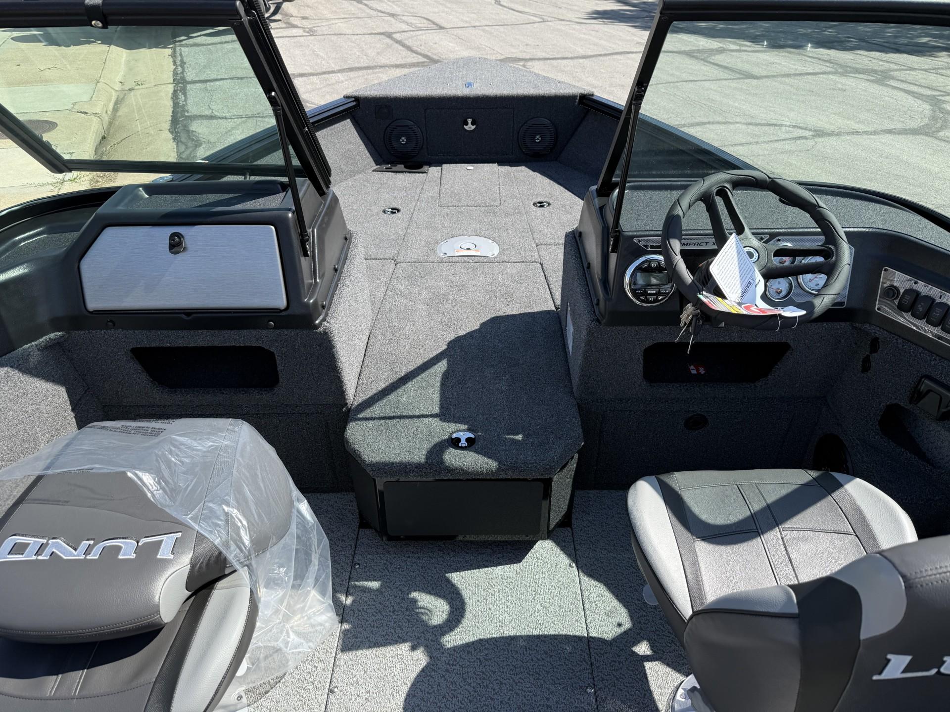 2025 Lund 1775 Impact XS boat interior with steering wheel and seating.