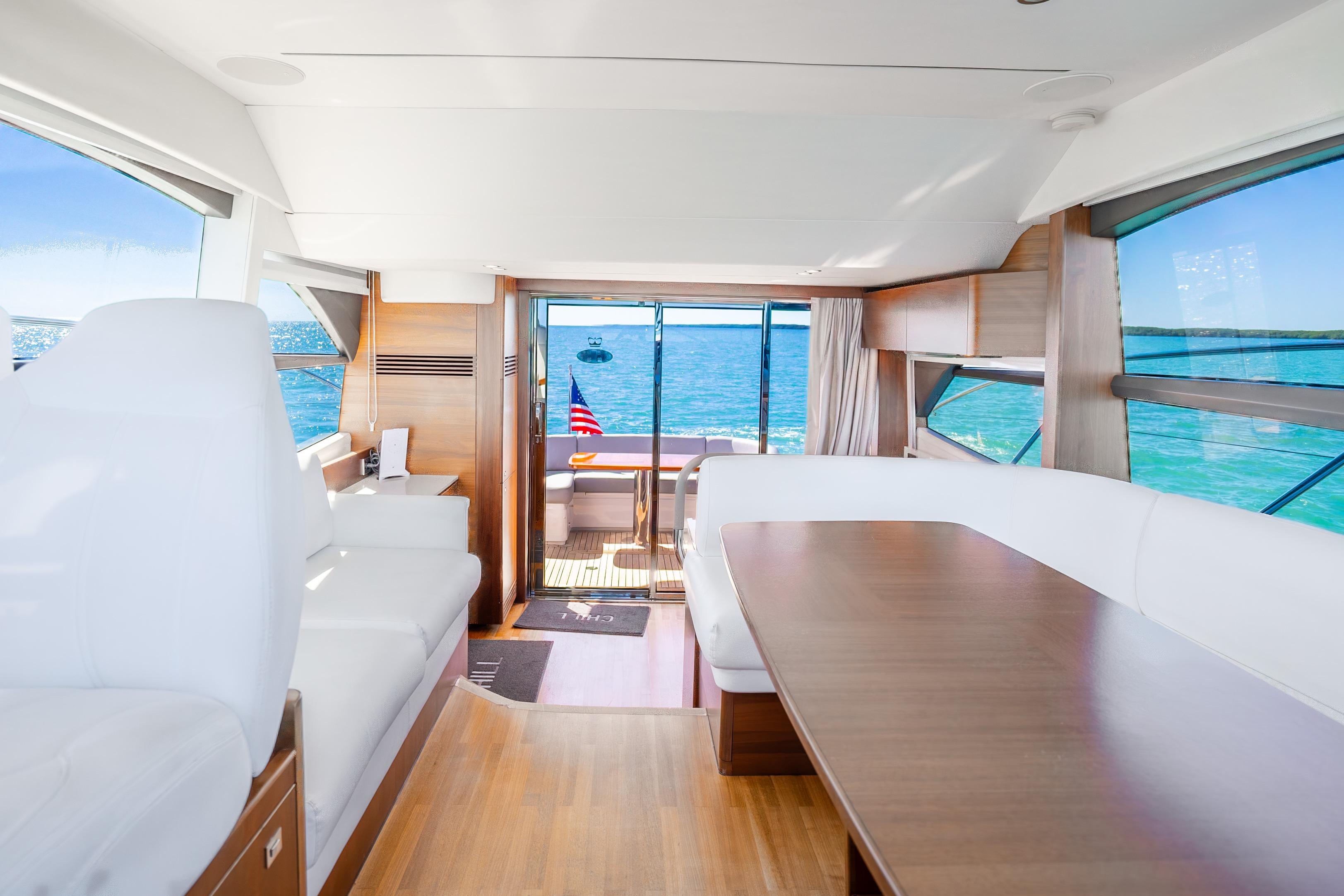 Luxurious interior of 2018 Princess F49 yacht with ocean view and elegant seating.